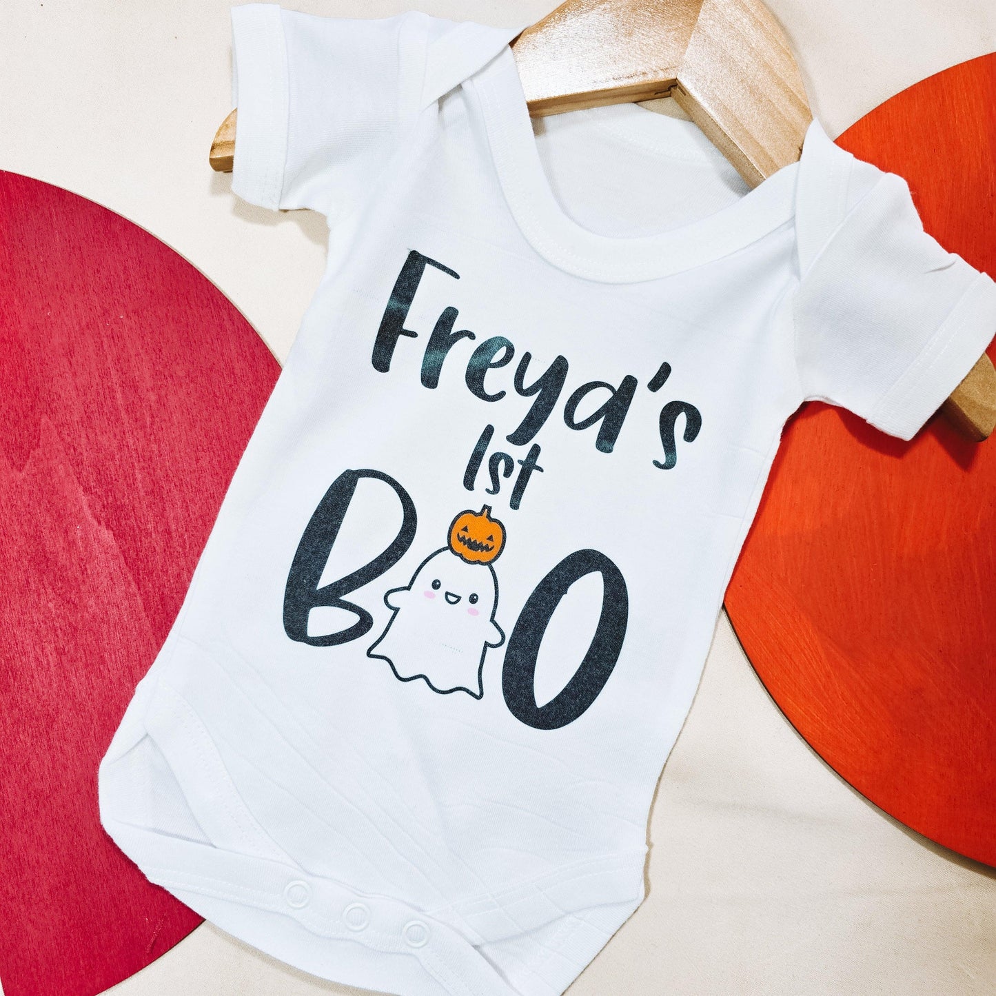Personalised baby vest for Halloween with "Name's First Boo" design, perfect for celebrating a babyβs first Halloween in a cute and spooky style.