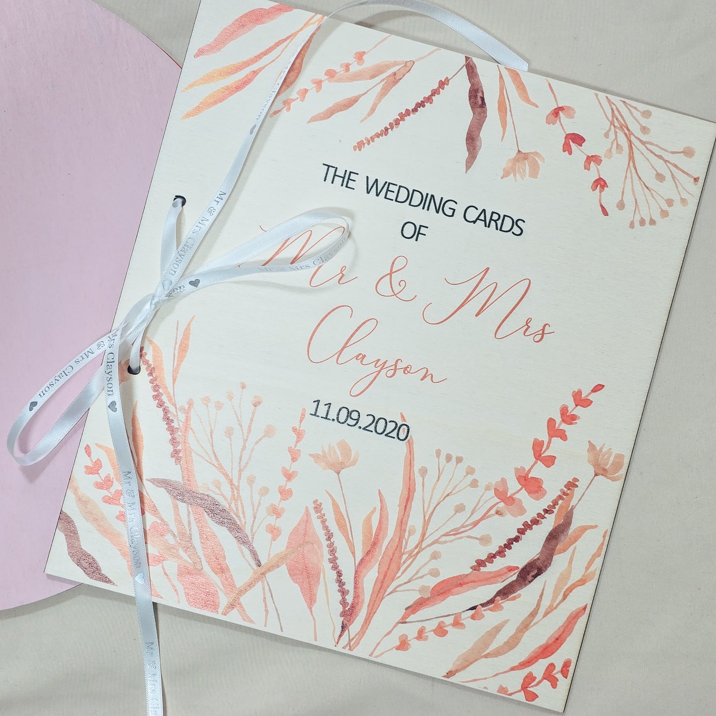 Floral wedding card with 'Mr & Mrs Clayson' and date on a light background