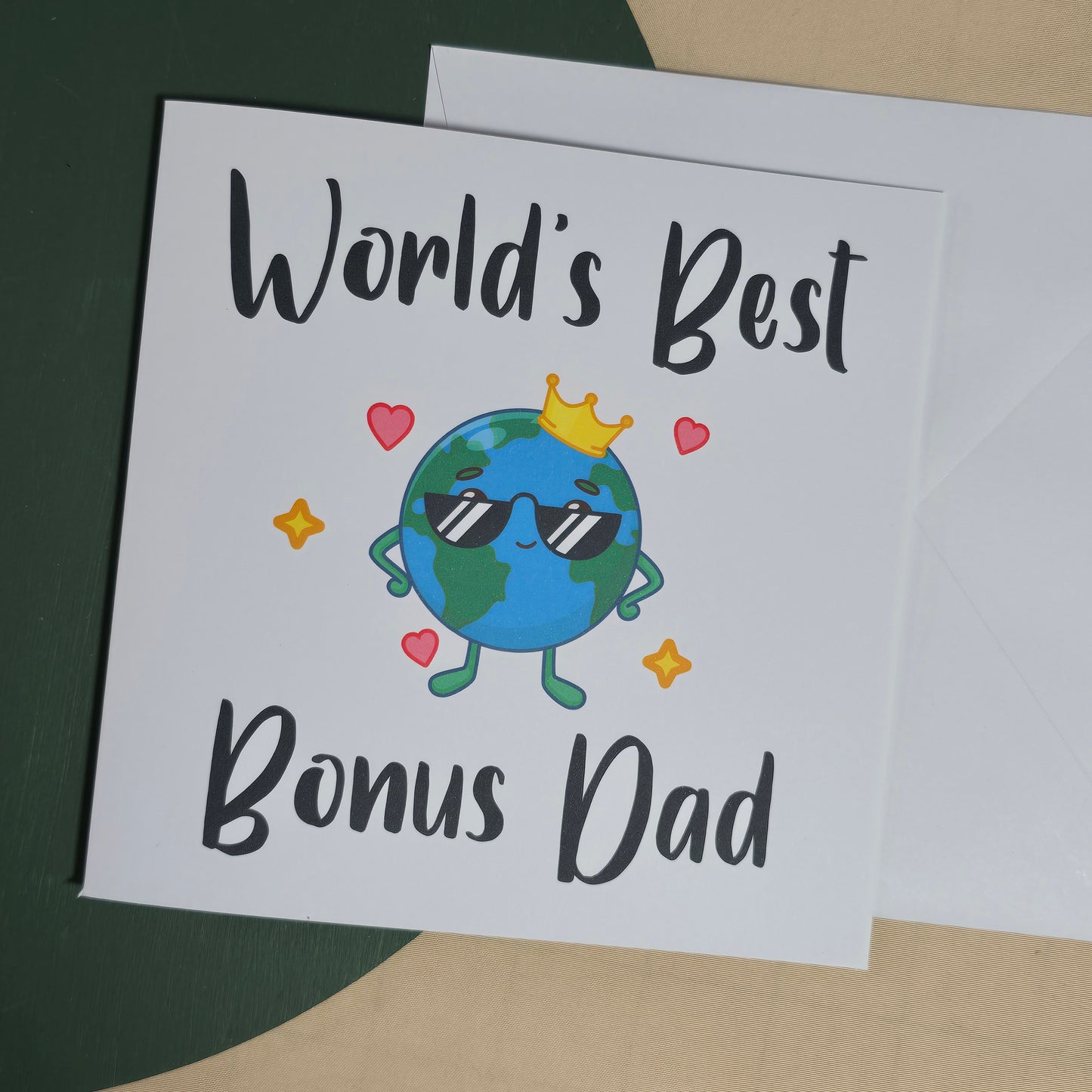 Card with cartoon Earth character wearing sunglasses and a crown, text 'World's Best Bonus Dad' on a white background.