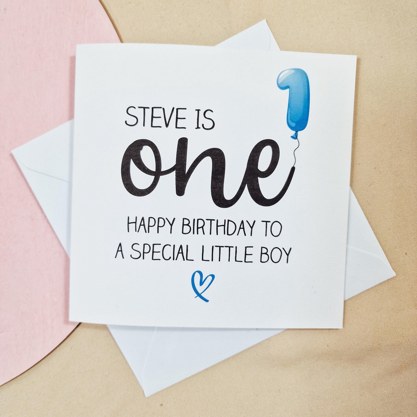First birthday card featuring a blue balloon in the shape of a 'one' with the message 'Name is one - Happy Birthday to a Special Little Boy.' Personalised with custom name and message inside.