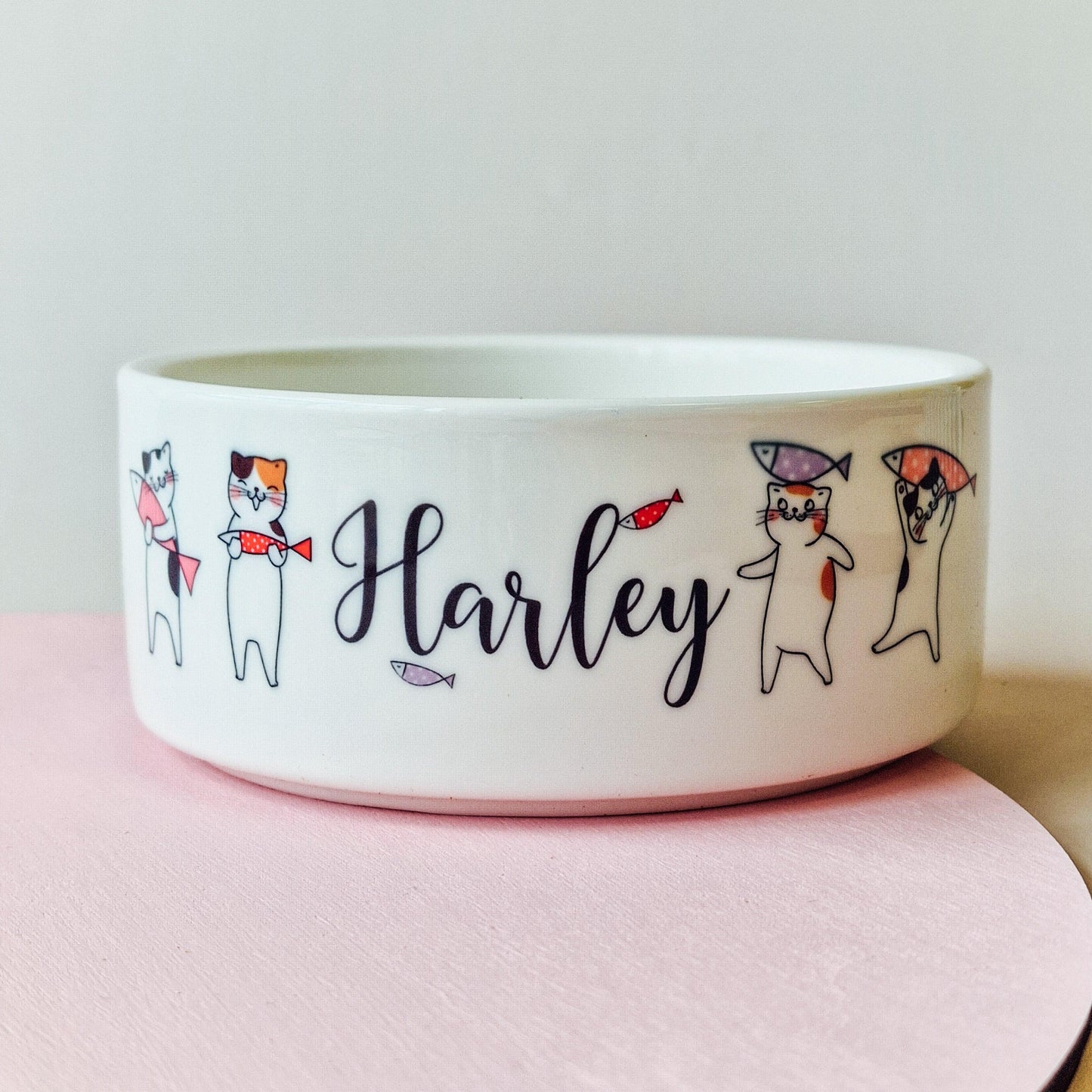 Personalised ceramic cat bowl with custom name and cute cat drawings, available as a food or water dish. Perfect gift for cats and kittens
