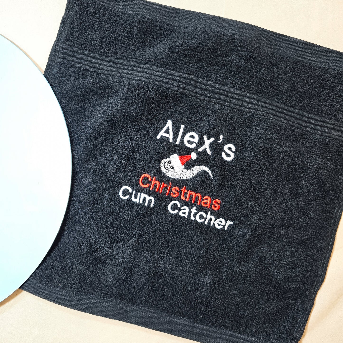 A festive, personalised Christmas cum catcher towel, white fabric with a cheeky holiday twist, perfect as a funny, adult-themed gag gift for the holidays.