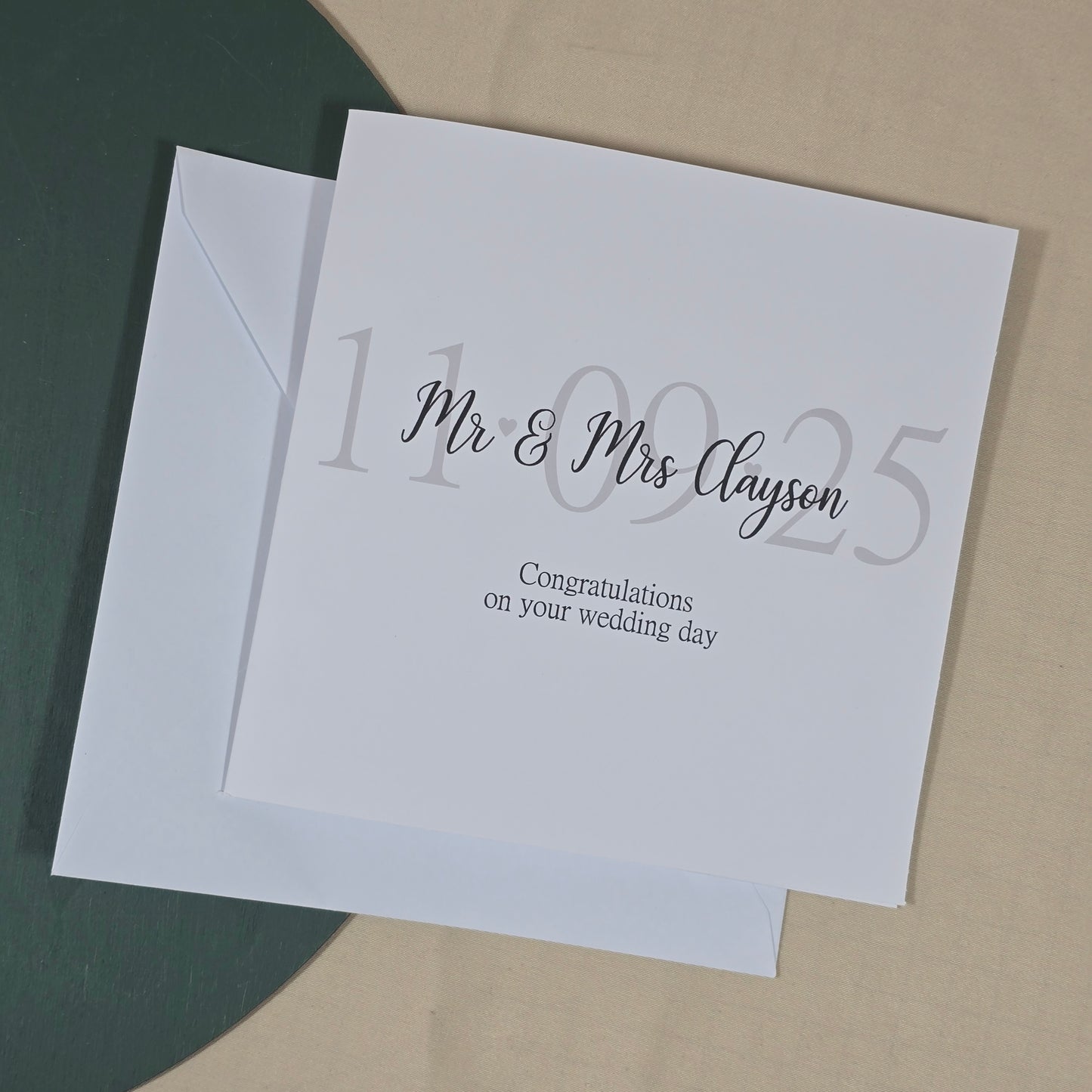 White card with silver text on a beige background