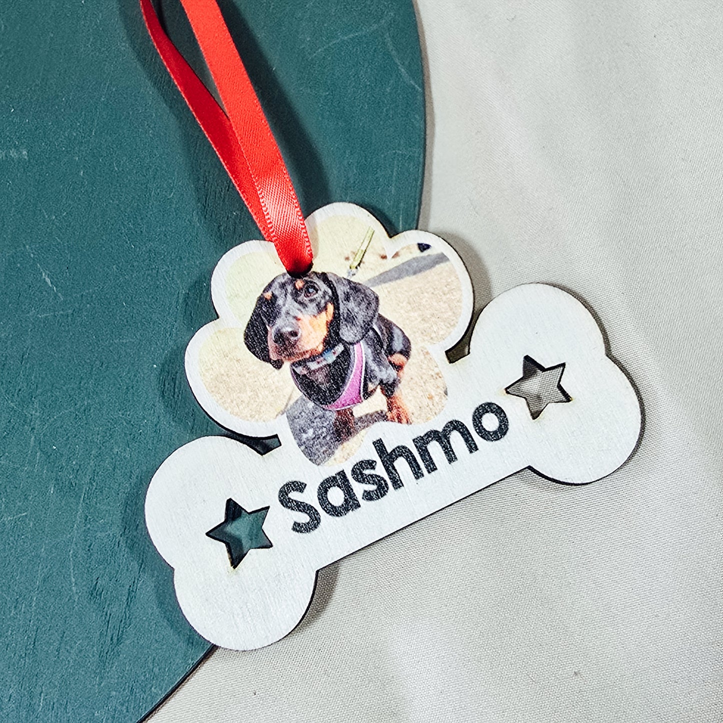 Personalized dog tag with a photo of a dog and the name 'name' on a textured surface.