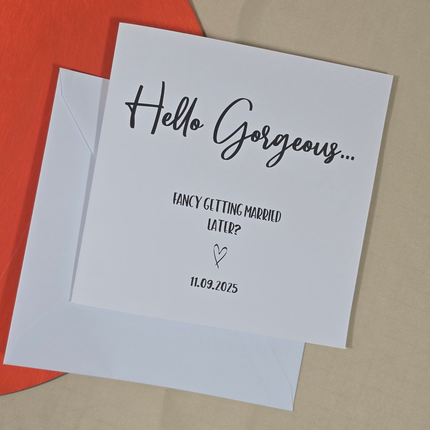 Card with 'Hello Gorgeous... Fancy getting married later?' text on a red and beige background
