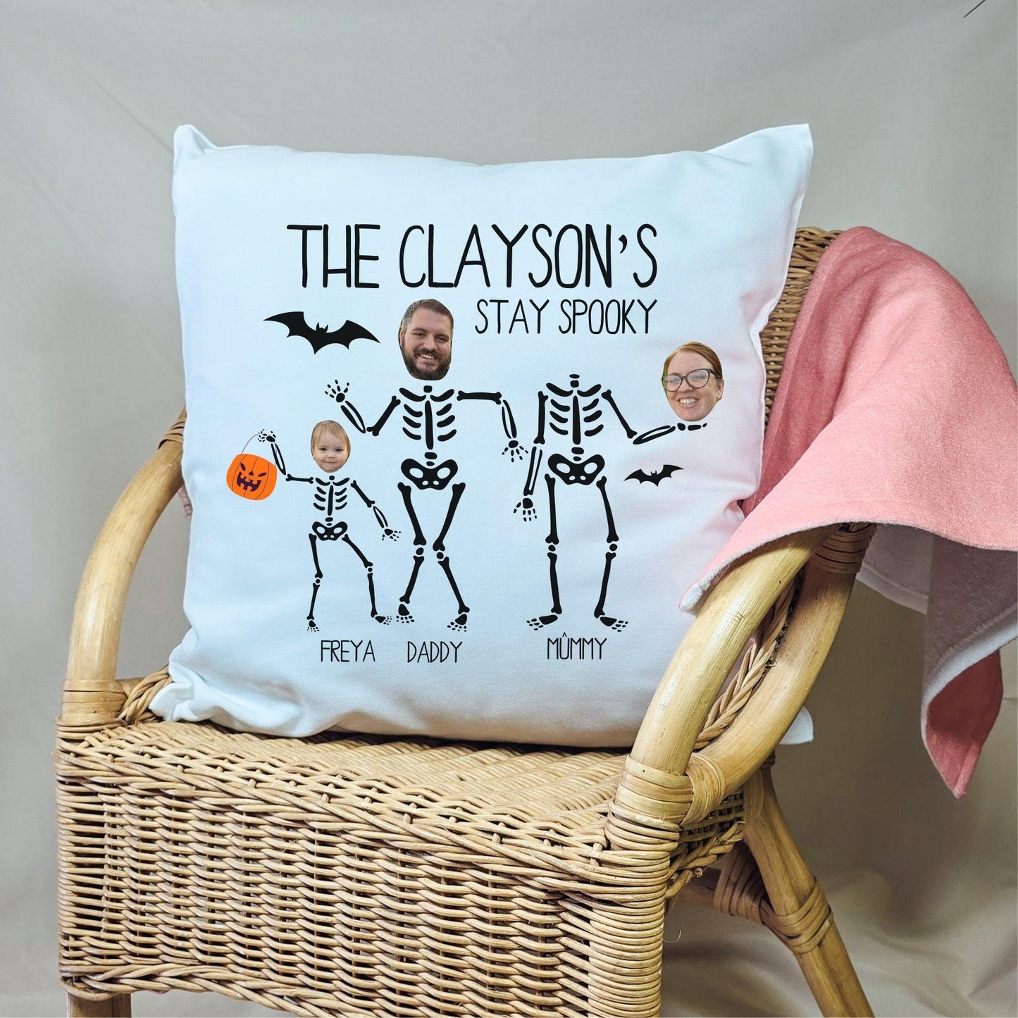 Custom Halloween cushion featuring skeletons with personalised photo faces and family names. The cushion is designed with a spooky skeleton theme and includes individual names for each family member.