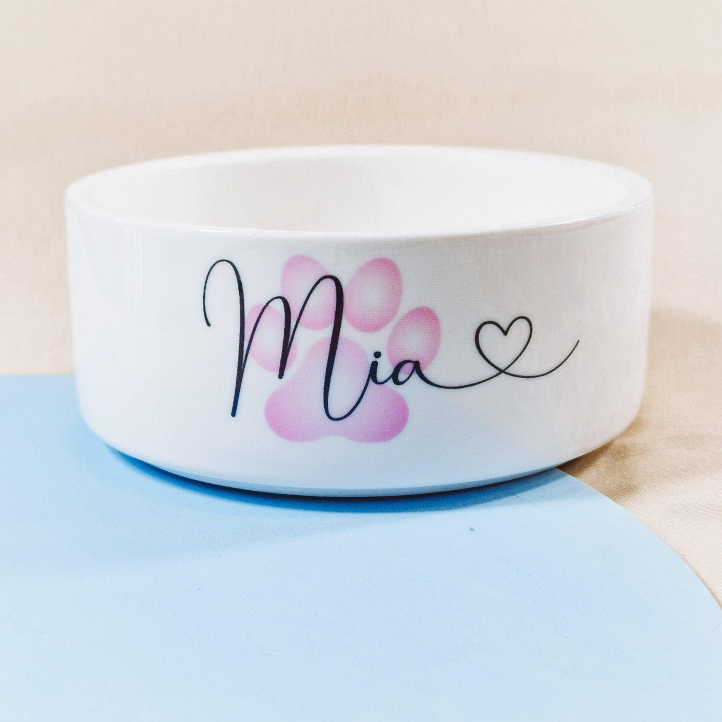 Personalised pet bowl featuring a paw print design with the dog's name and a heart at the end. Available in small, medium, and large sizes, perfect for adding a touch of love to your pet’s feeding time.
