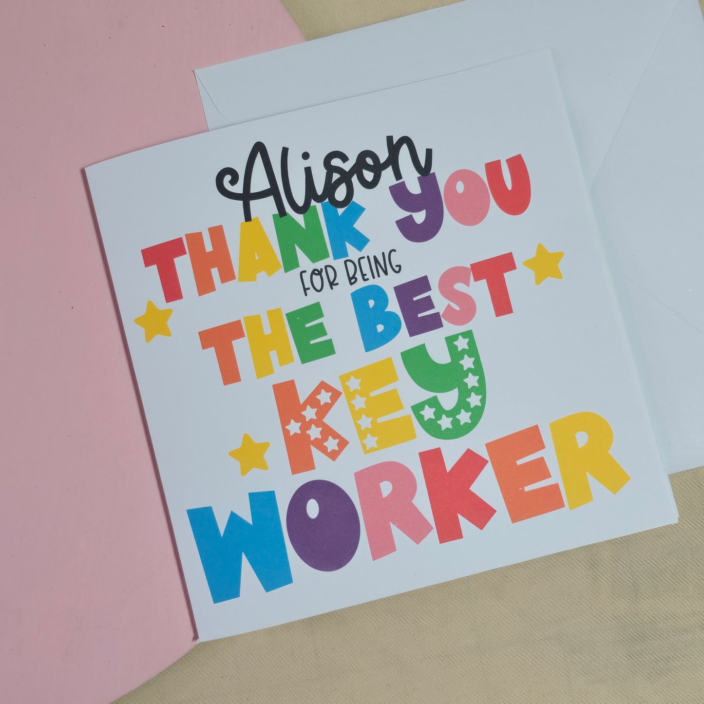 Colorful card with text on a pink surface