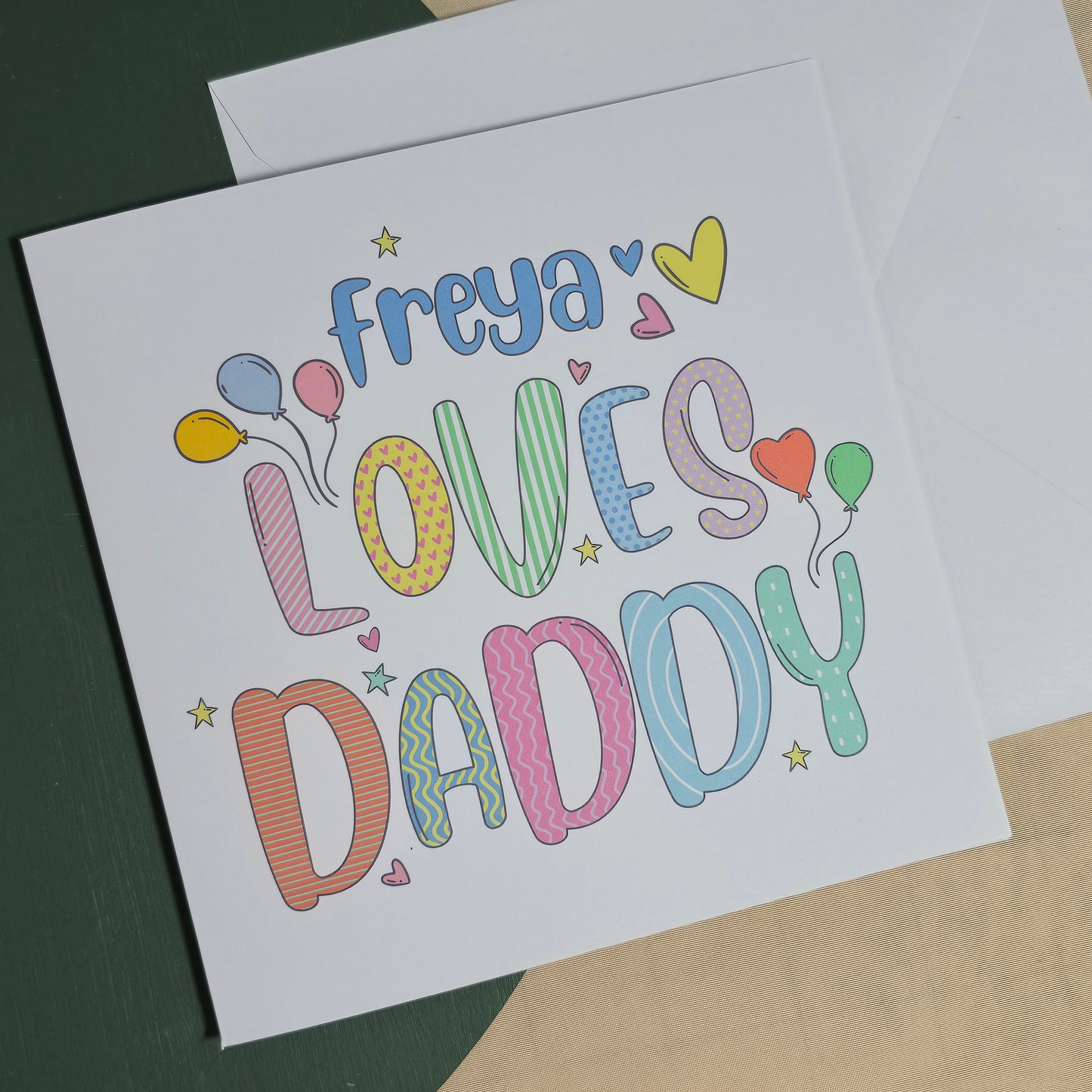 Colorful card with 'freya loves daddy' text on a plain background
