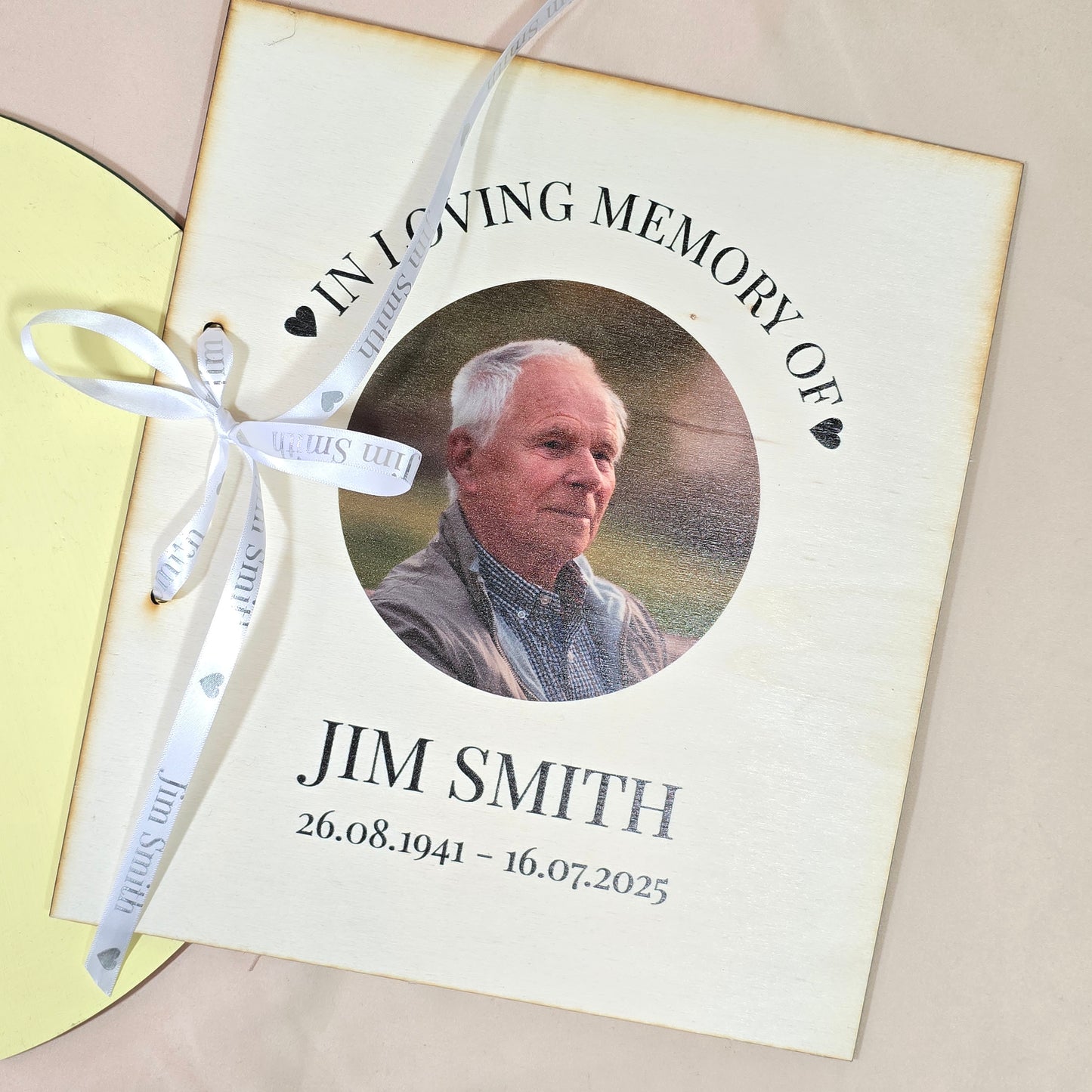 Personalised card book featuring a photo of a loved one with "In Loving Memory" text, name, and dates on a white 24x28cm cover with ribbon holes for storing memory cards.