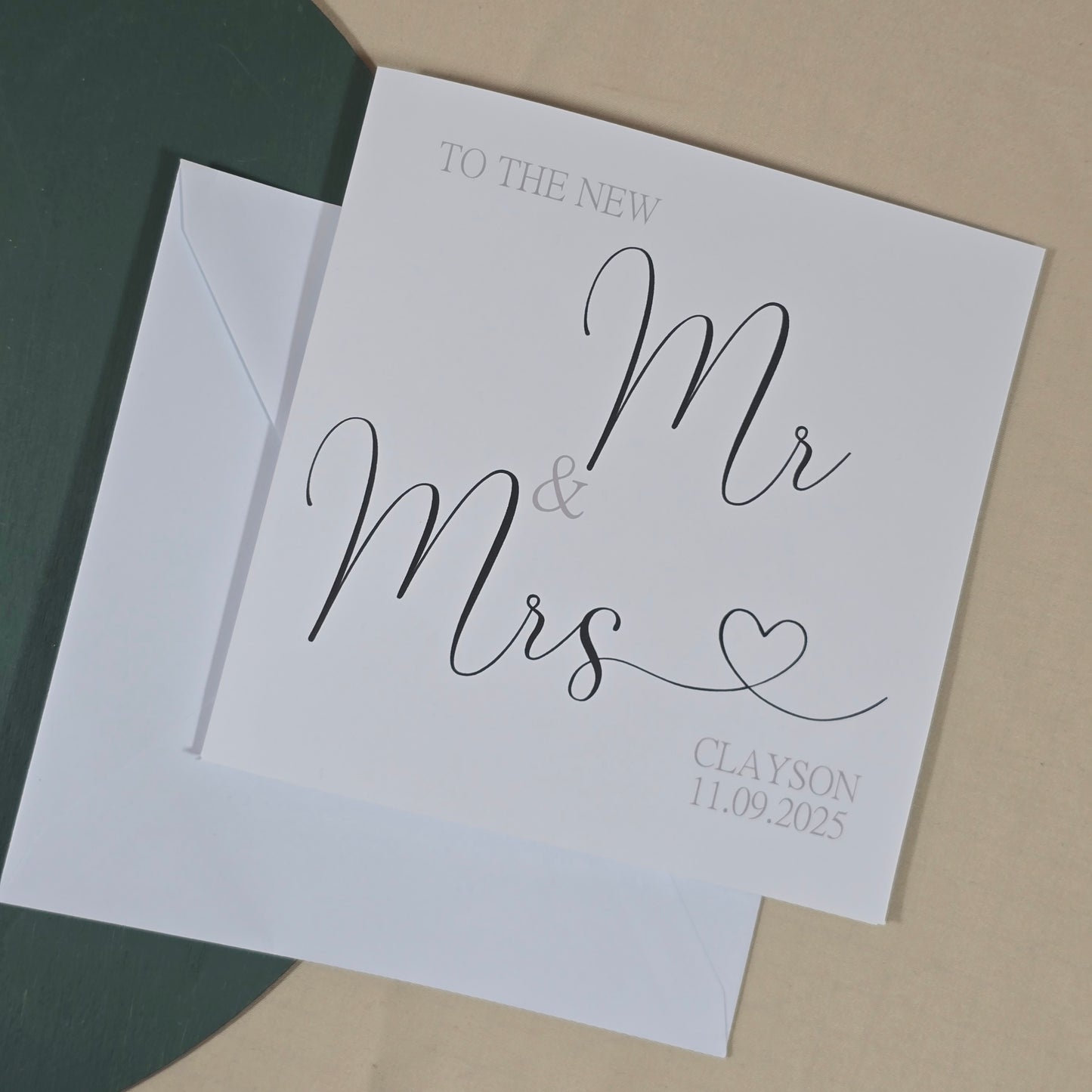 White card with 'Mr & Mrs' text on a beige background