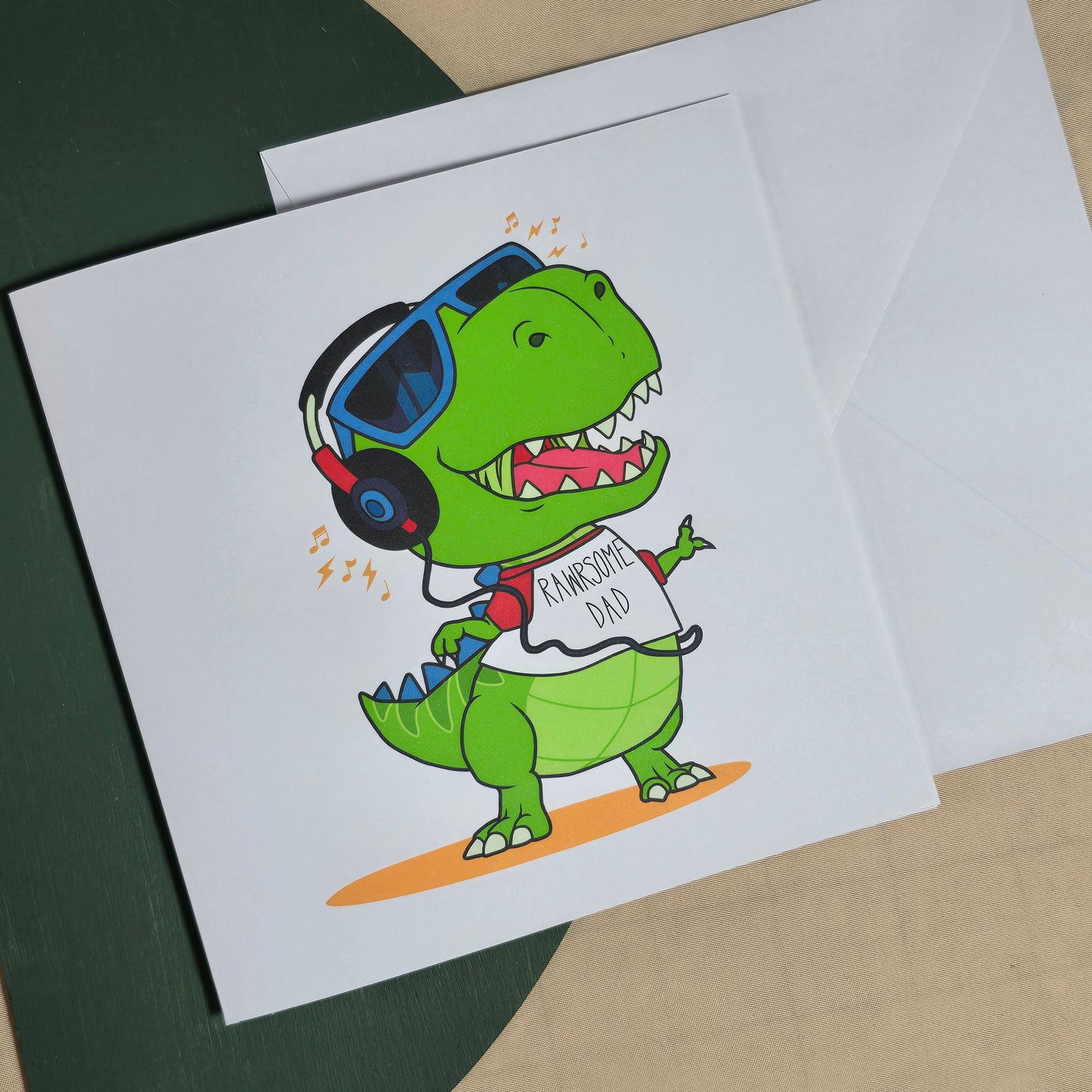 Card with cartoon dinosaurs and sunglasses on a plain background
