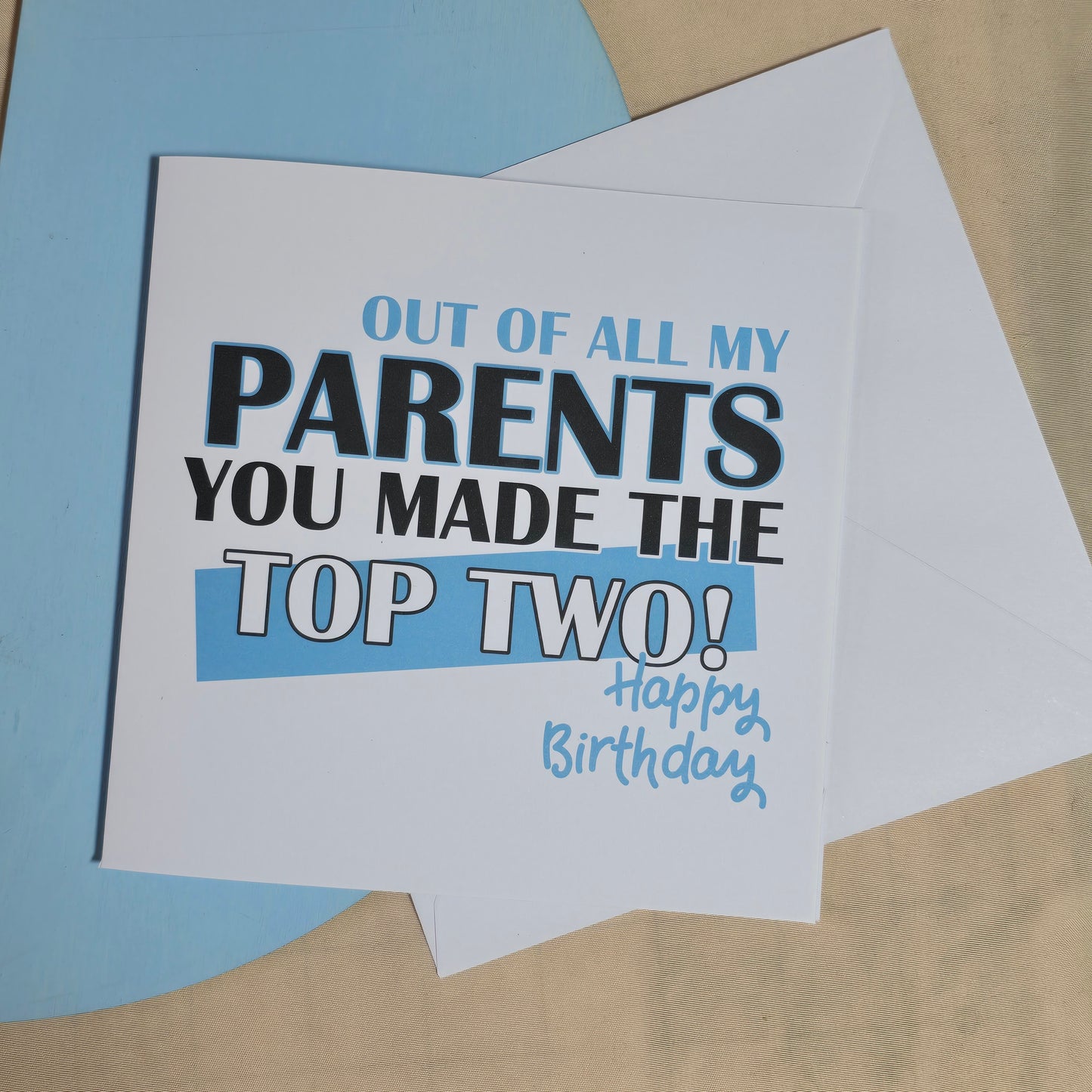 Birthday card with humorous text on a beige and blue background