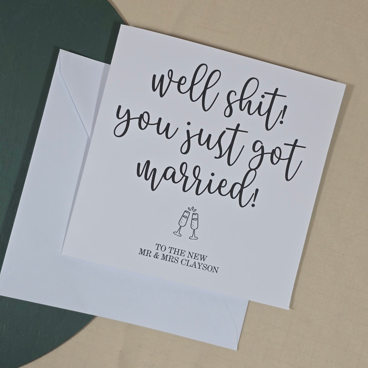 Wedding card with humorous text on a plain background