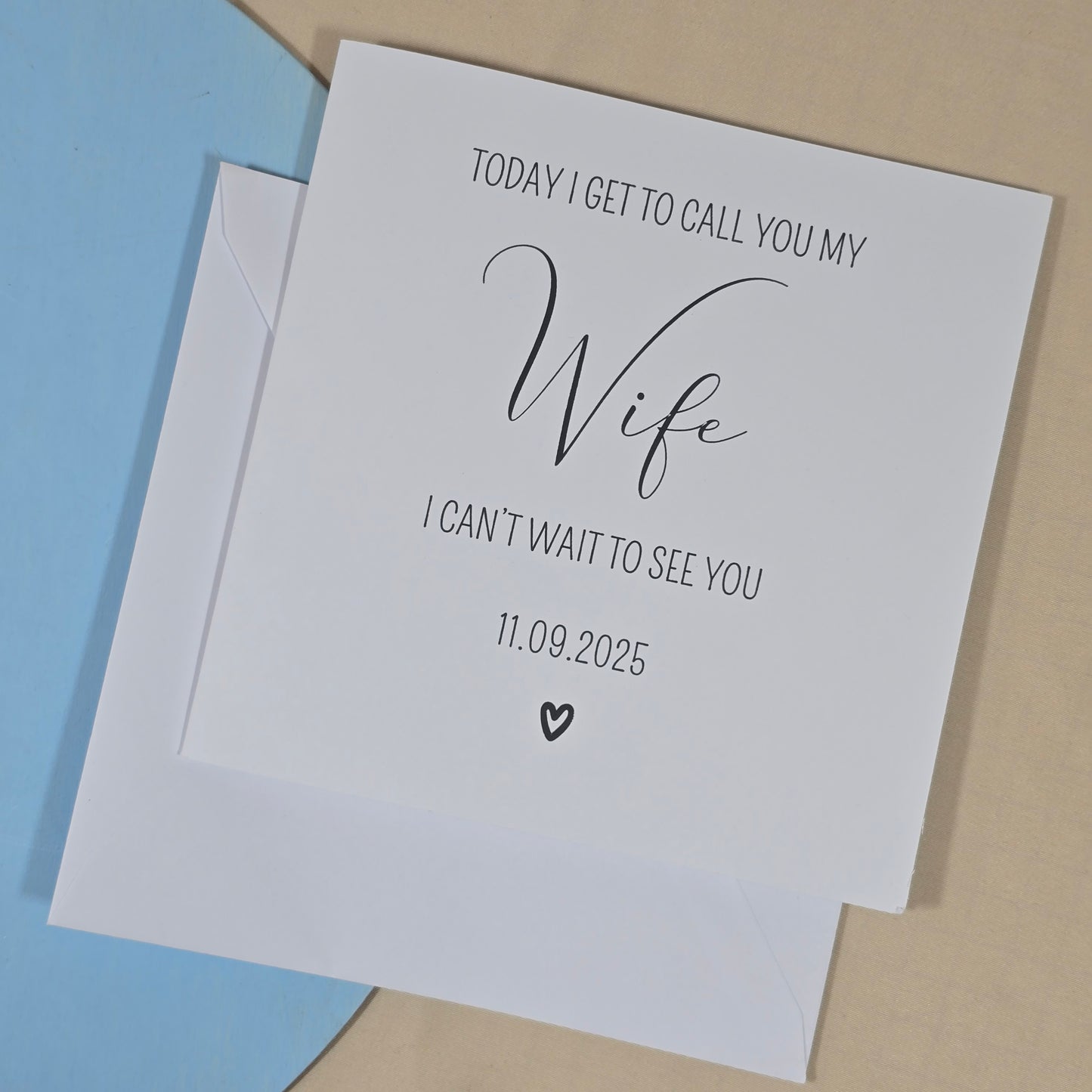 Greeting card with text 'Today I get to call you my wife. I can't wait to see you' on a beige and blue background.
