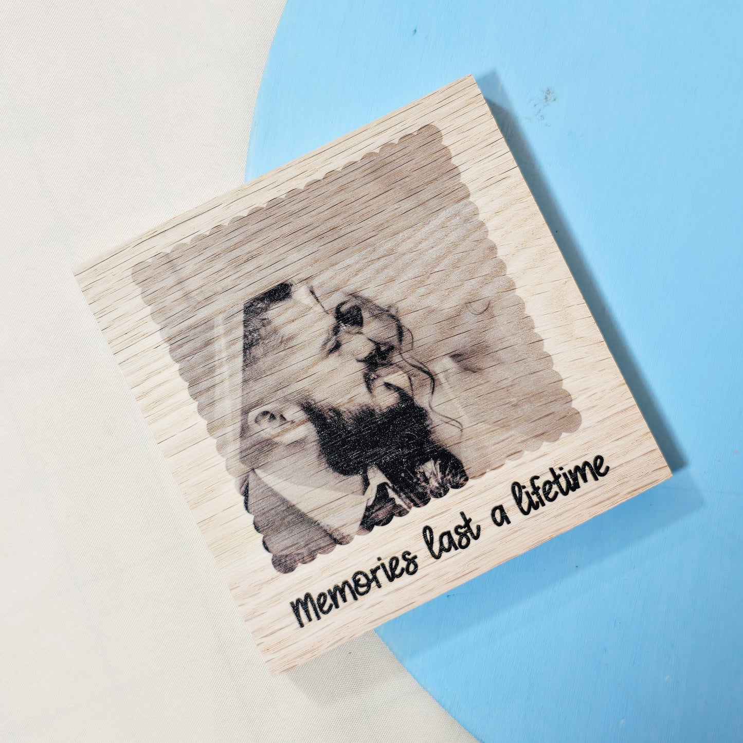 A wooden square coaster with a custom photo and text design. The wood grain subtly shows through the photo, making it a rustic and meaningful gift for Valentine's Day or a wooden anniversary.