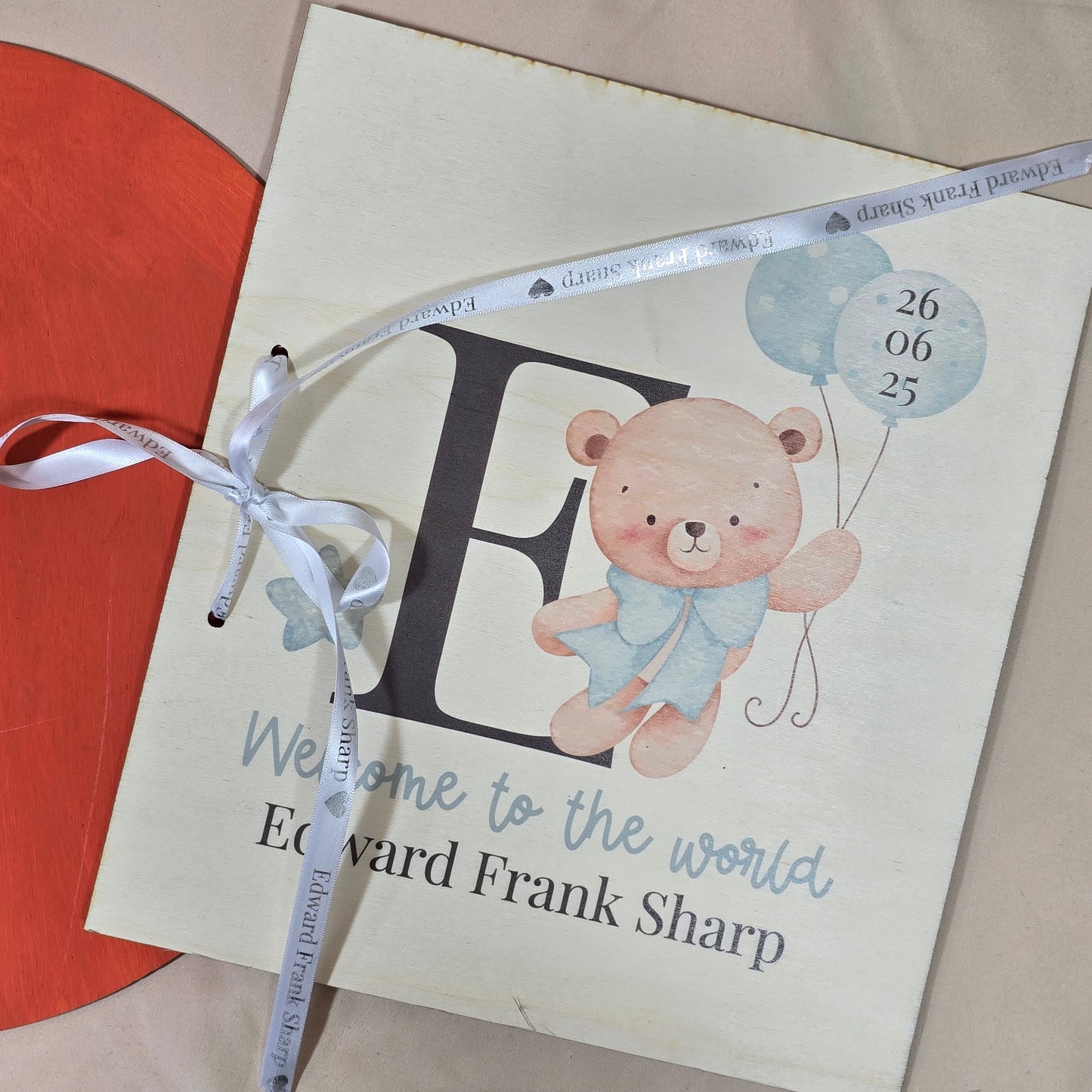 Baby shower invitation with teddy bear and balloons on a beige background