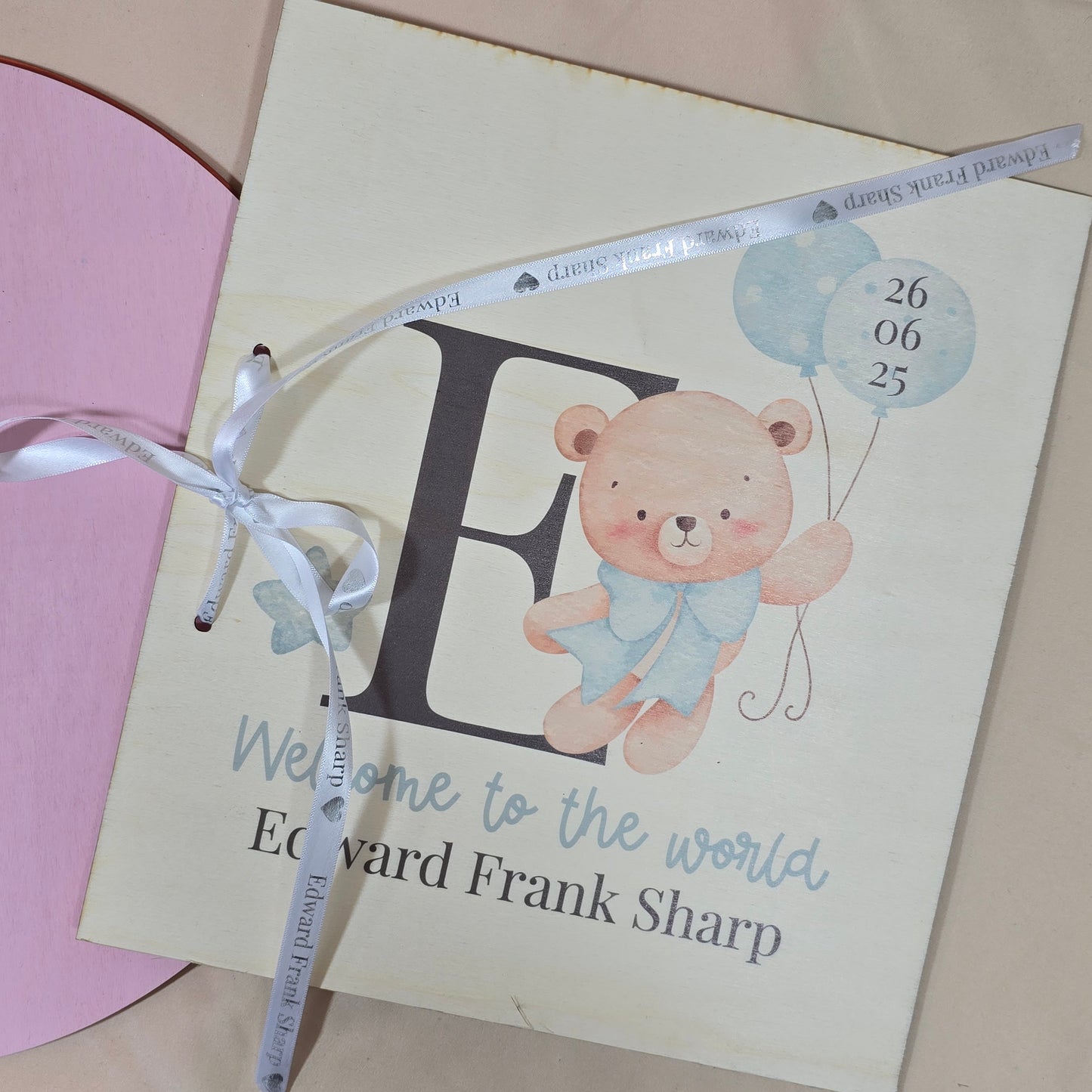 Baby shower invitation with teddy bear illustration and personalized text.