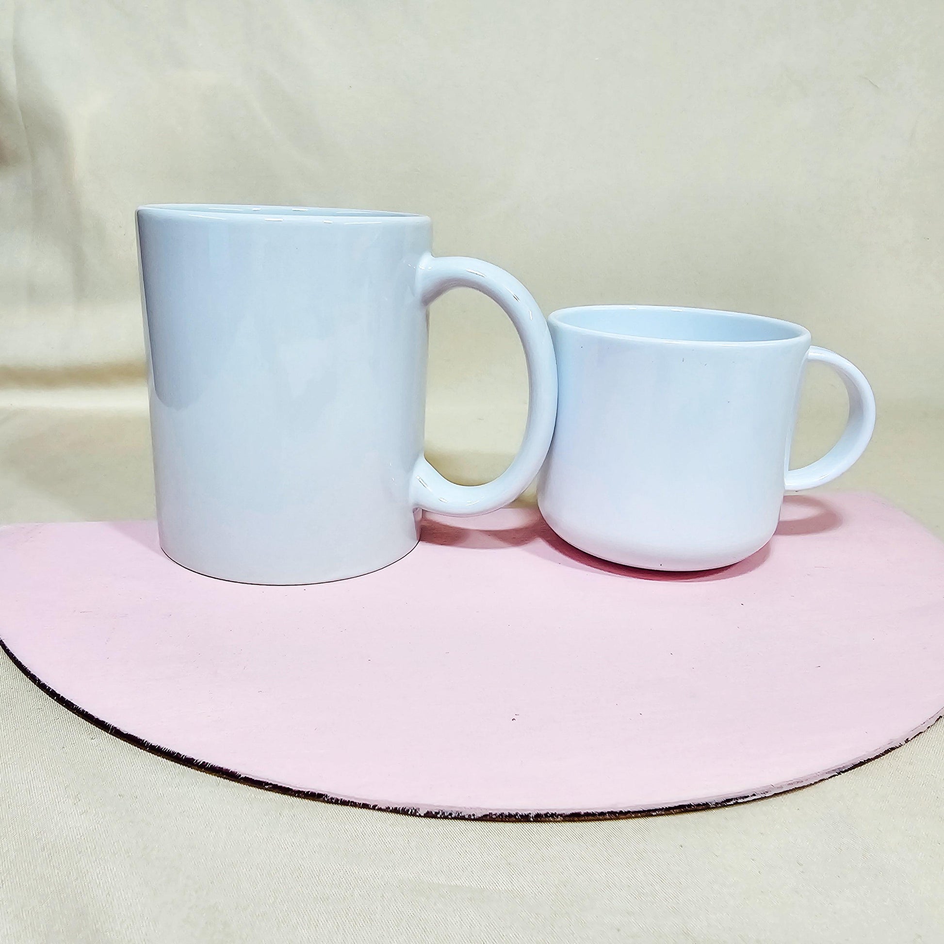 Comparison of a 10oz mug and a 6oz polyemer mug, showcasing their sizes side by side.