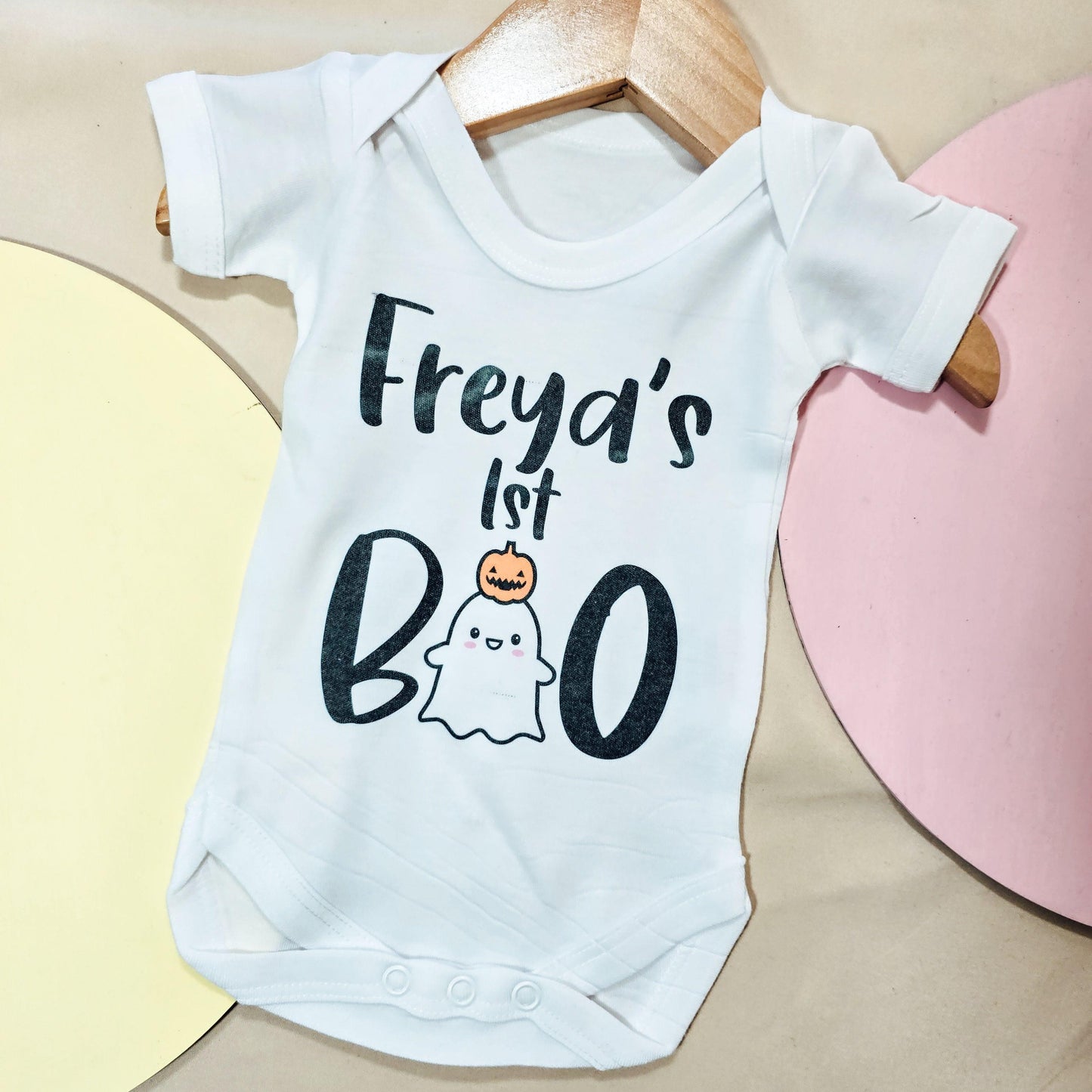 Personalised baby vest for Halloween with "Name's First Boo" design, perfect for celebrating a baby’s first Halloween in a cute and spooky style.