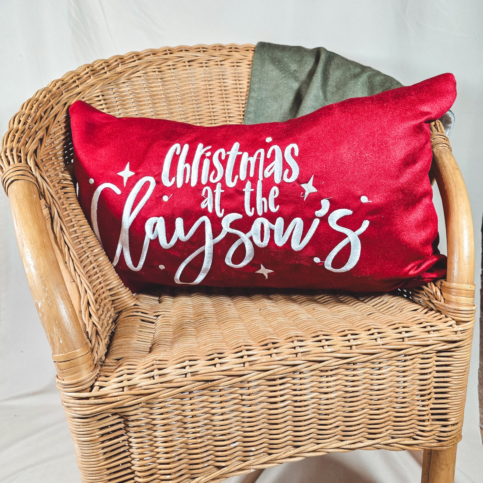 Red personalised Christmas cushion cover 50x30cm with “Christmas at the [Name]’s,” festive holiday home décor