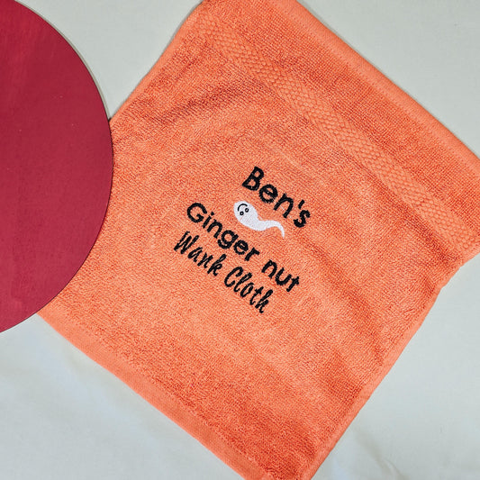 Personalised "Name's Ginger Nut Wank Cloth" with humorous embroidery, displayed on a soft fabric background.