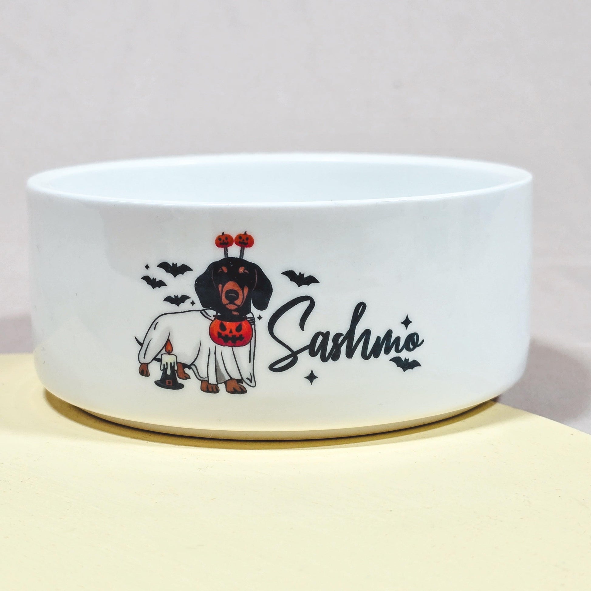 Halloween dog bowl featuring a dachshund with the pet's name, perfect for sausage dogs with a spooky theme.