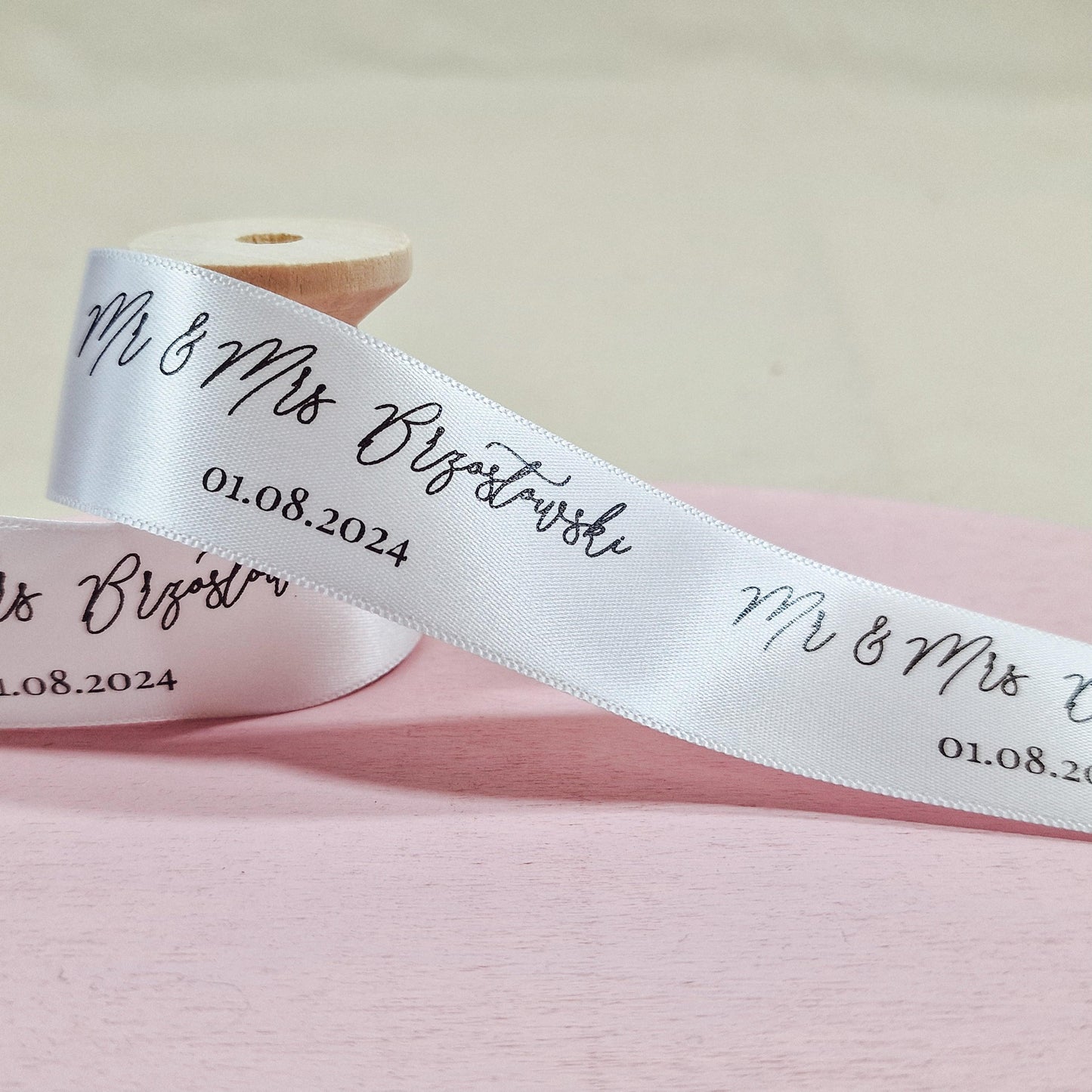 Custom wedding ribbon printed with "Mr & Mrs [Name]" and wedding date. 25mm wide, available in various colours, with options for "Mr & Mr," "Mrs & Mrs," and other titles.