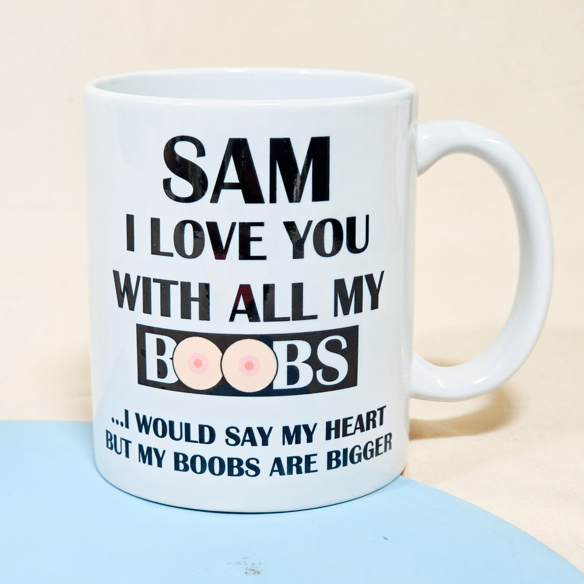 A white ceramic mug with the humorous phrase "[Name], I love you with all my boobs. I would say heart, but my boobs are bigger," perfect for a funny personalised Valentine's or anniversary gift.

