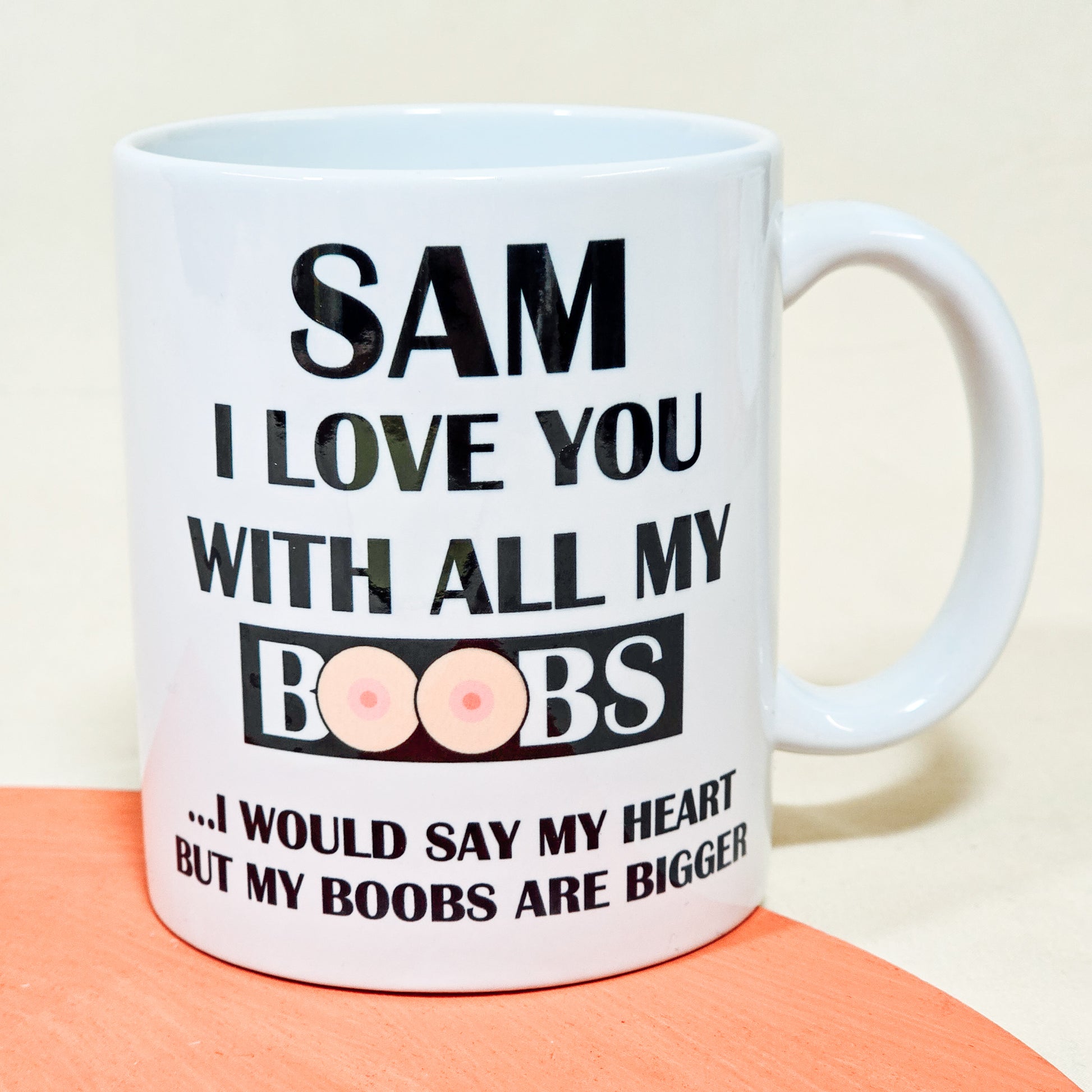 A white ceramic mug with the humorous phrase "[Name], I love you with all my boobs. I would say heart, but my boobs are bigger," perfect for a funny personalised Valentine's or anniversary gift.

