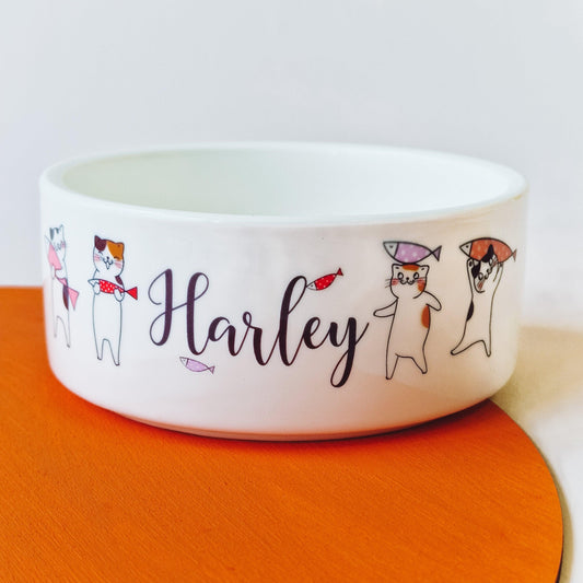 Personalised ceramic cat bowl with custom name and cute cat drawings, available as a food or water dish. Perfect gift for cats and kittens