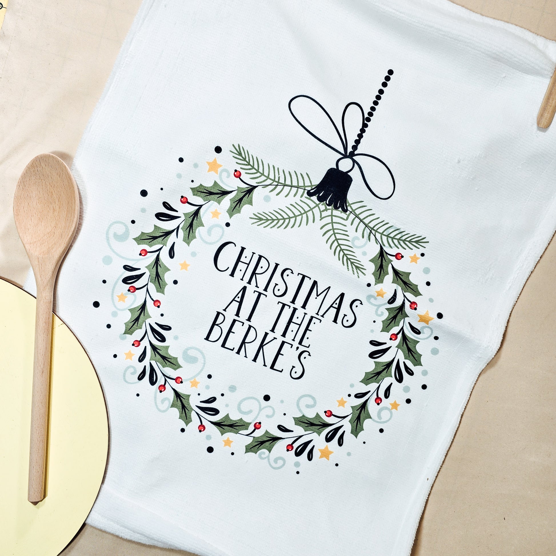 Personalised Christmas tea towel featuring the text "Christmas at the [name]".

