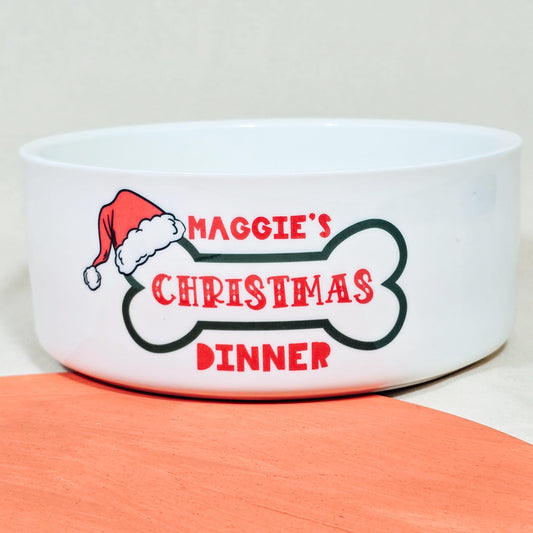 A personalised ceramic pet bowl with festive text “[Name]’s Christmas Dinner,” perfect for serving holiday meals to your dog or cat.