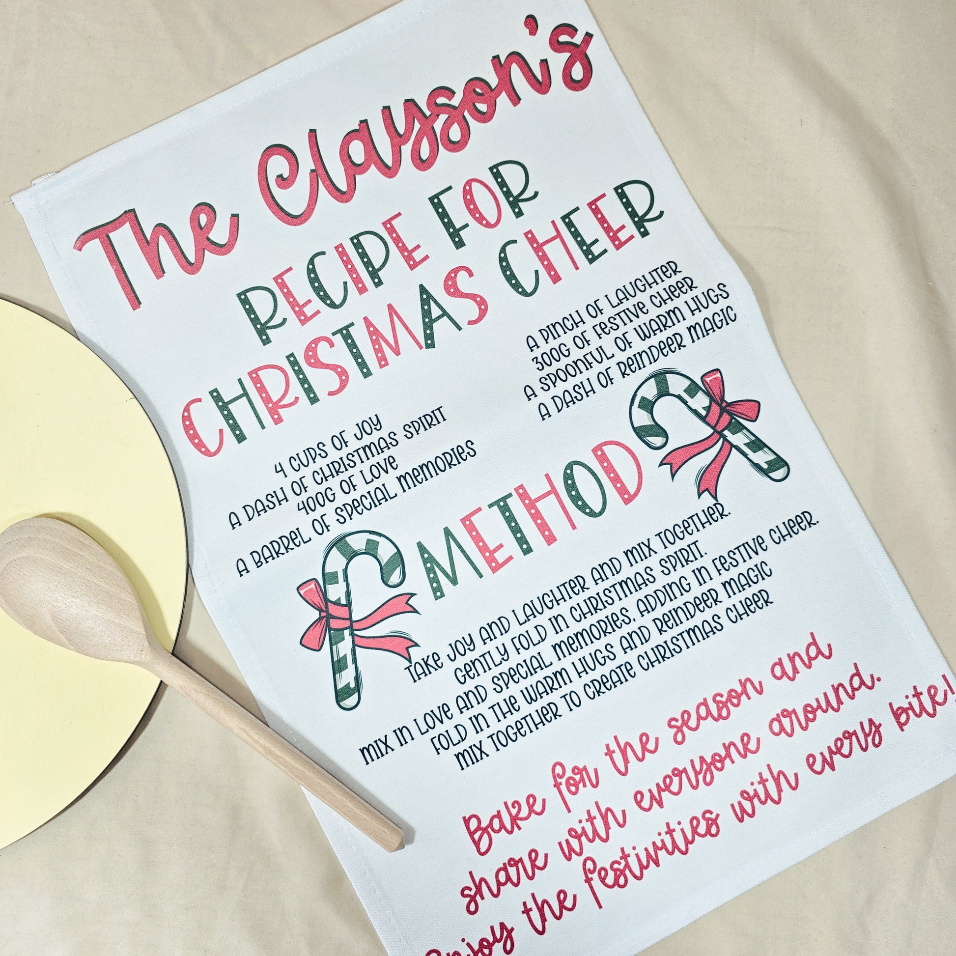 Christmas-themed recipe card with decorative text and a wooden spoon on a beige background