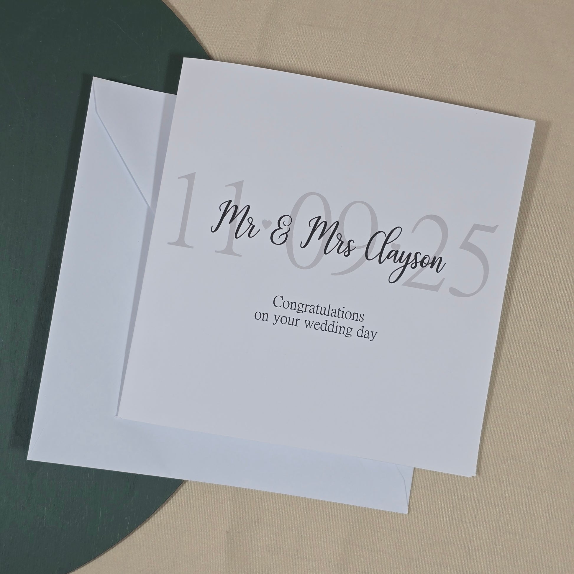 White card with silver text on a beige background