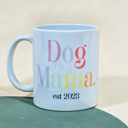 A white ceramic mug with "Dog Mama Est [Date]" in elegant script, available with a matching pet bowl in various sizes.

