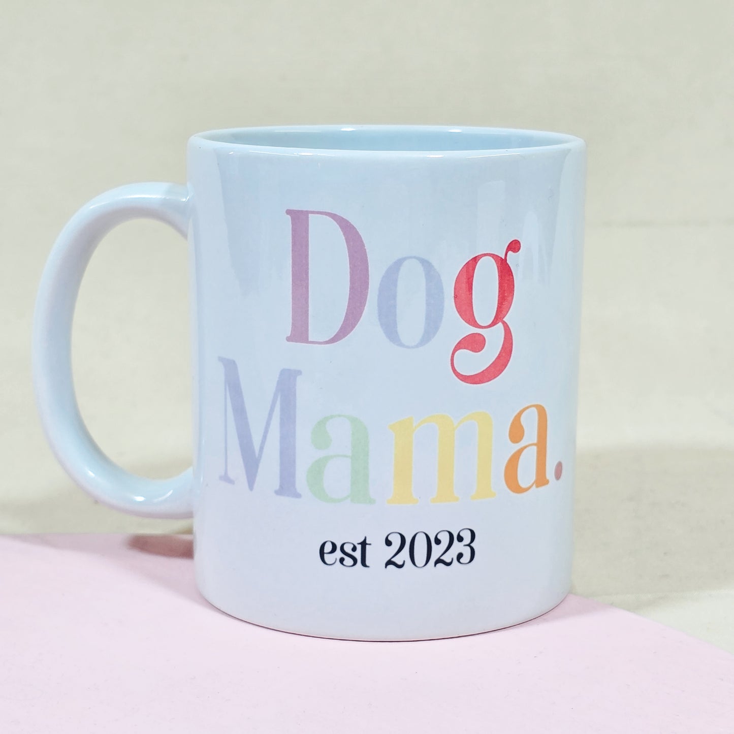 A white ceramic mug with "Dog Mama Est [Date]" in elegant script, available with a matching pet bowl in various sizes.

