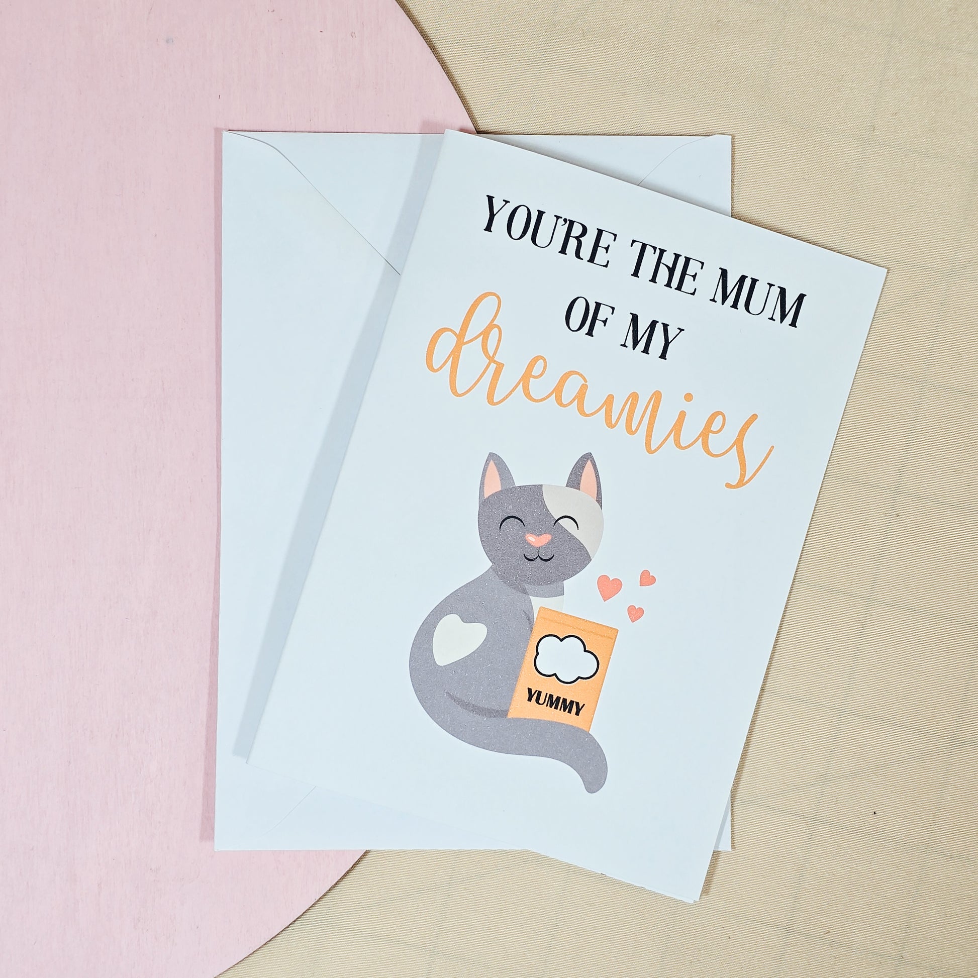 A6 Mother’s Day card featuring a cute cat holding Dreamies treats with the text “You're The Mum of My Dreamies.” Comes with a white envelope.







