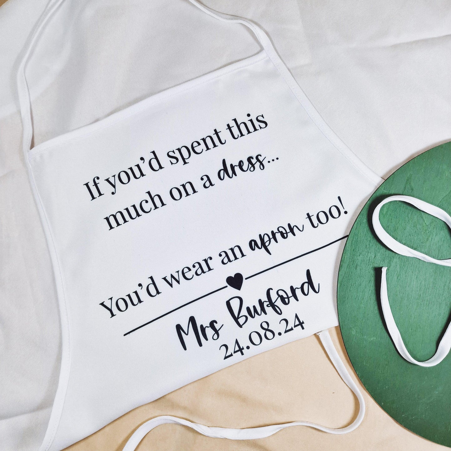 Personalised wedding dress apron with the text "If you spent this much on a dress, you'd wear an apron too!" customised with the bride's name and wedding date.