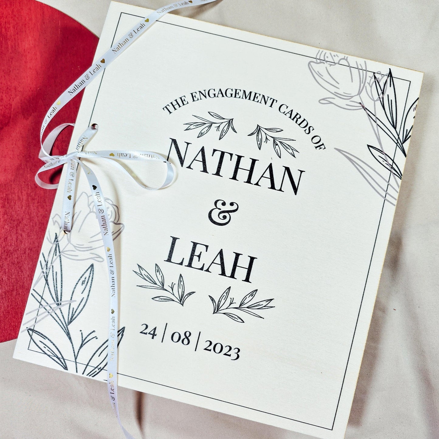 Personalised engagement card book featuring the names [Name & Name] and engagement date.