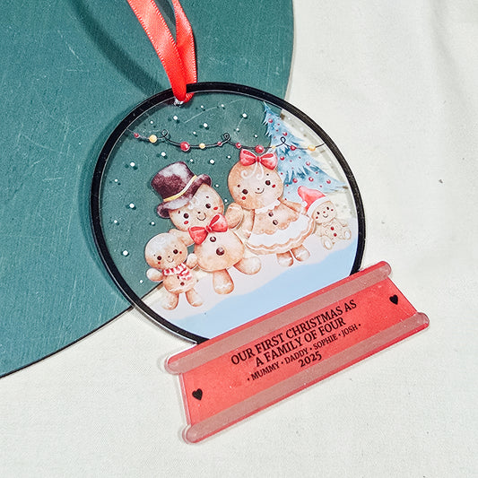 Personalised acrylic Christmas snowglobe decoration with gingerbread family, “Our First Christmas as a Family of Four,” custom names and year
