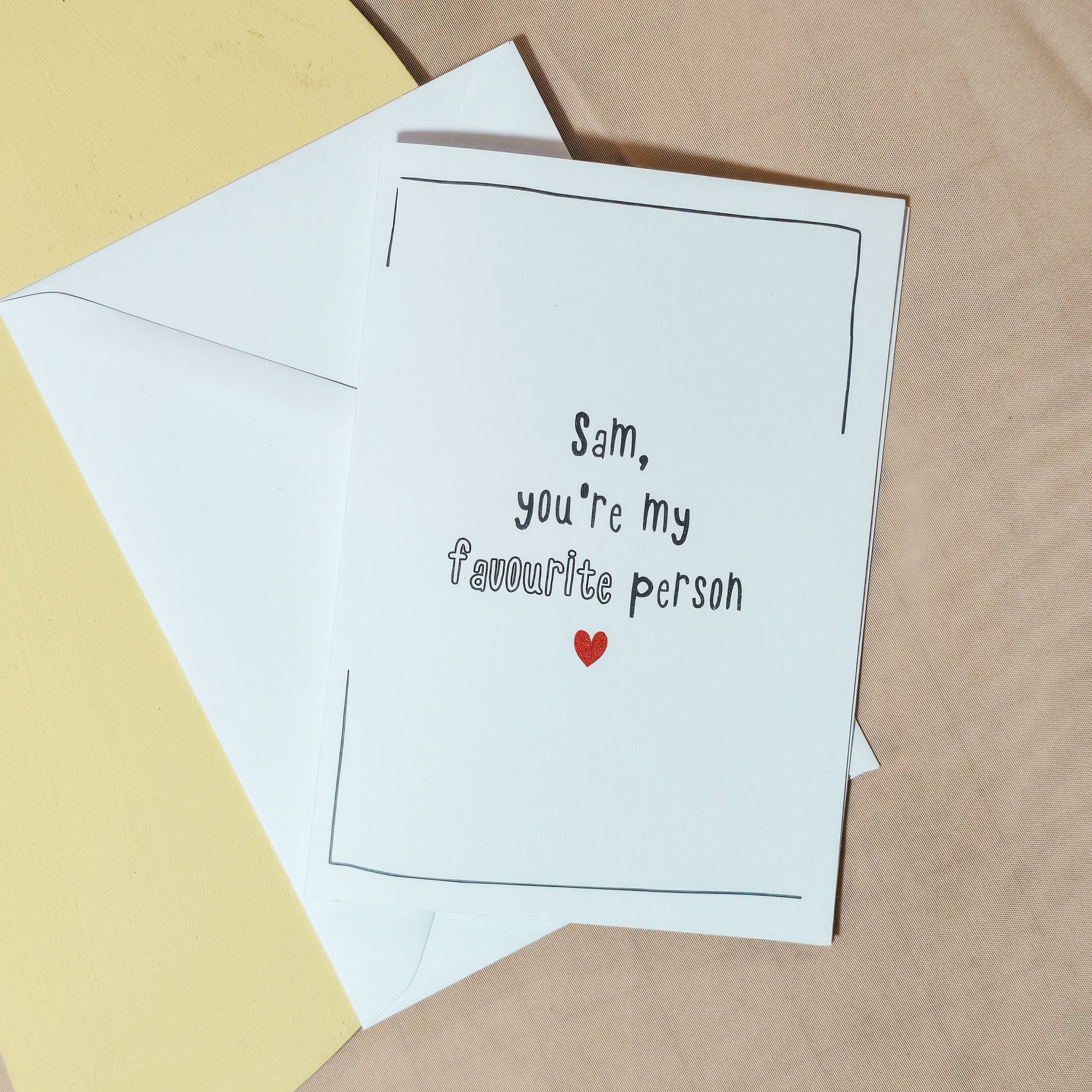 A personalised Valentine’s or anniversary card with the message “[Name], you’re my favourite person” and a small red heart underneath.