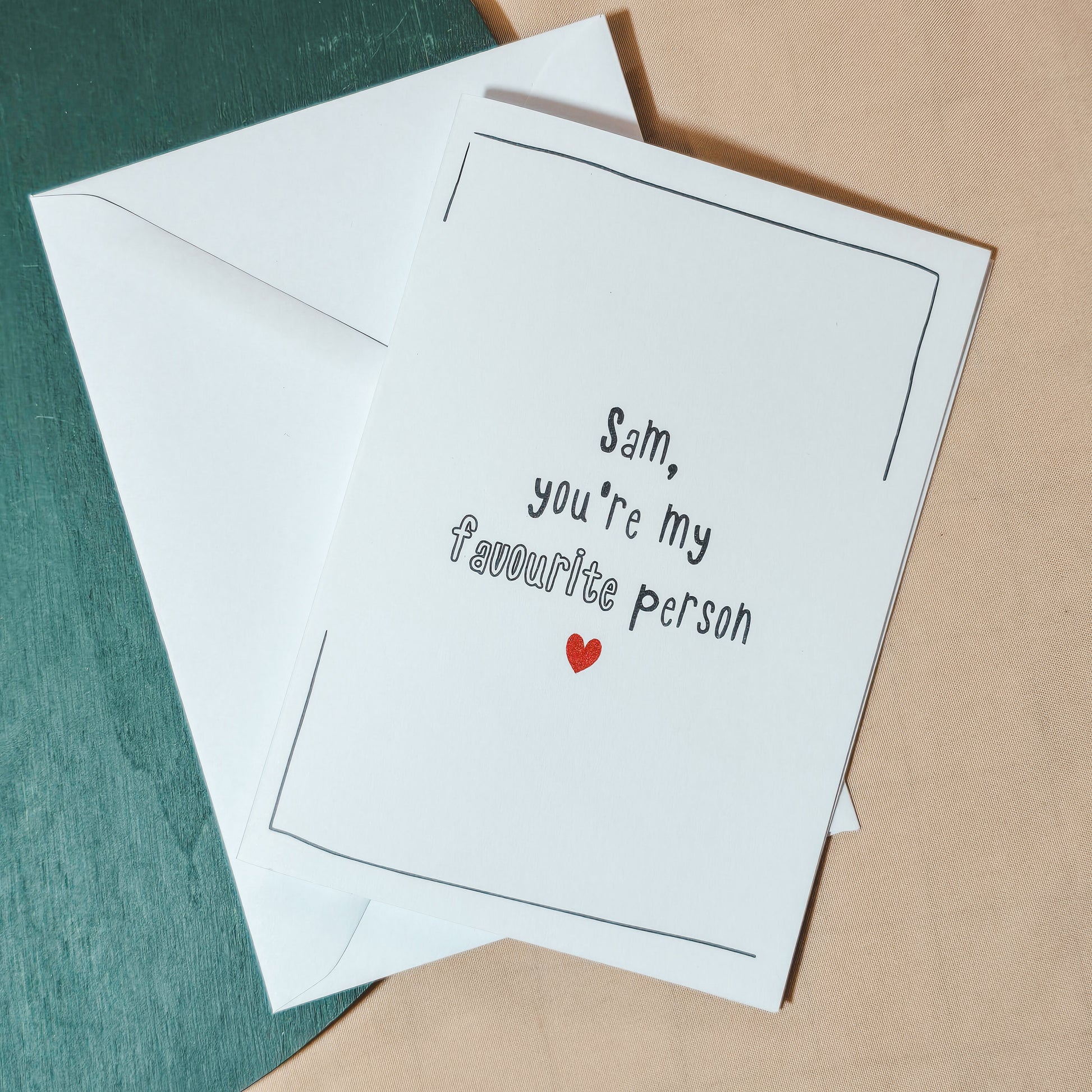 A personalised Valentine’s or anniversary card with the message “[Name], you’re my favourite person” and a small red heart underneath.