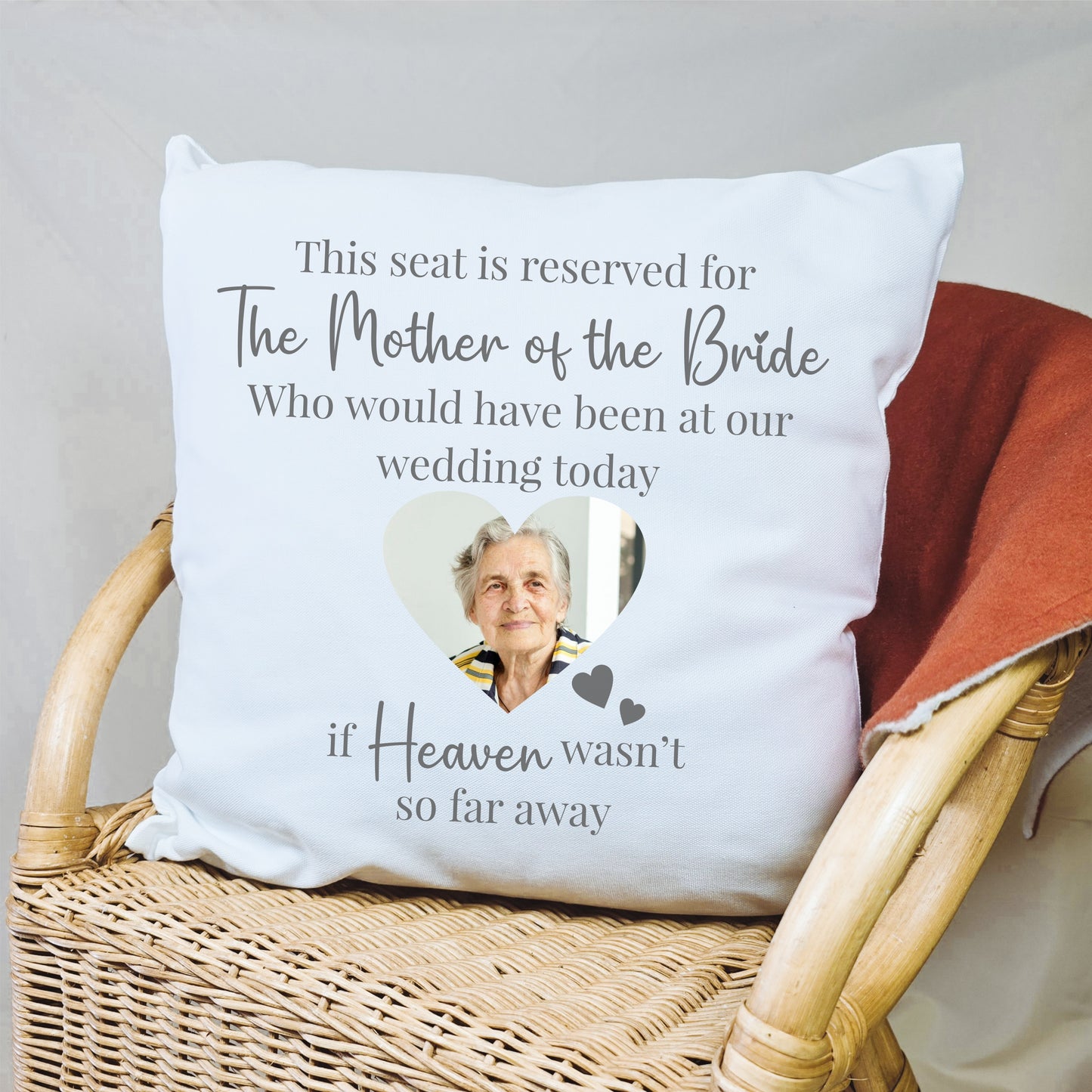 Personalised wedding memorial cushion with a sentimental message and a photo of a loved one, placed on a seat to honour their memory.

