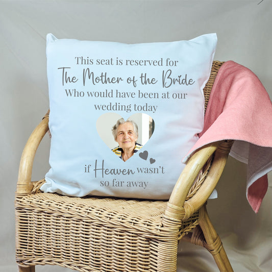 Personalised wedding memorial cushion with a sentimental message and a photo of a loved one, placed on a seat to honour their memory.

