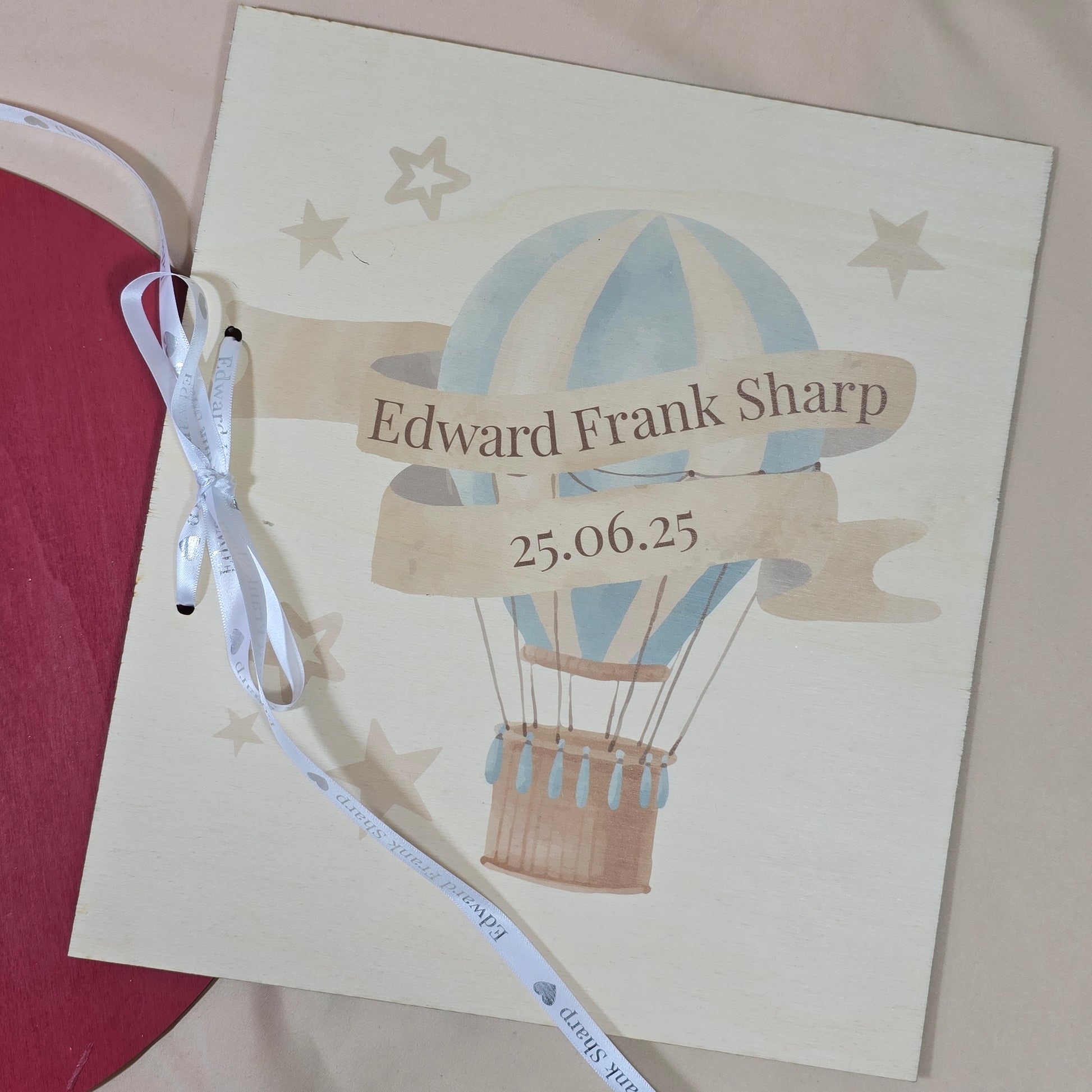 Invitation card with hot air balloon design and text on a beige background