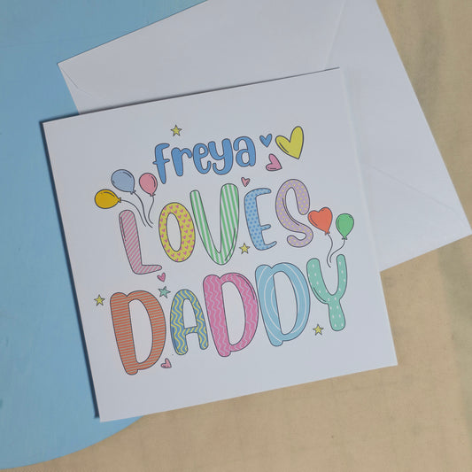Greeting card with colorful text and envelope on a light brown background