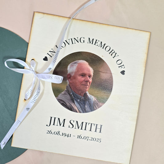 Memorial card with a photo of a man named Jim Smith and a ribbon on a beige background