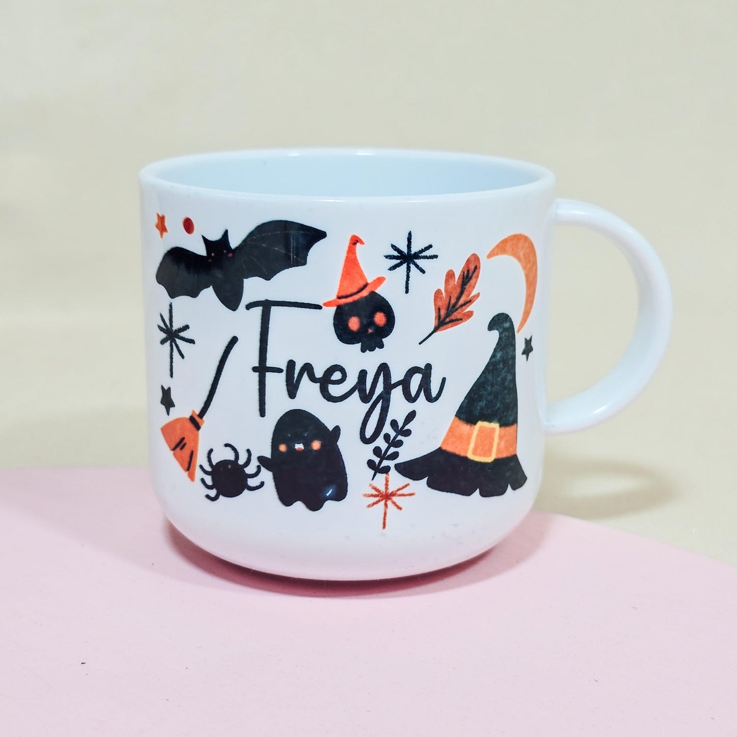 Personalised 6oz unbreakable Halloween kids mug featuring bats, witches hats, and custom name. Option to add a matching adult mug.