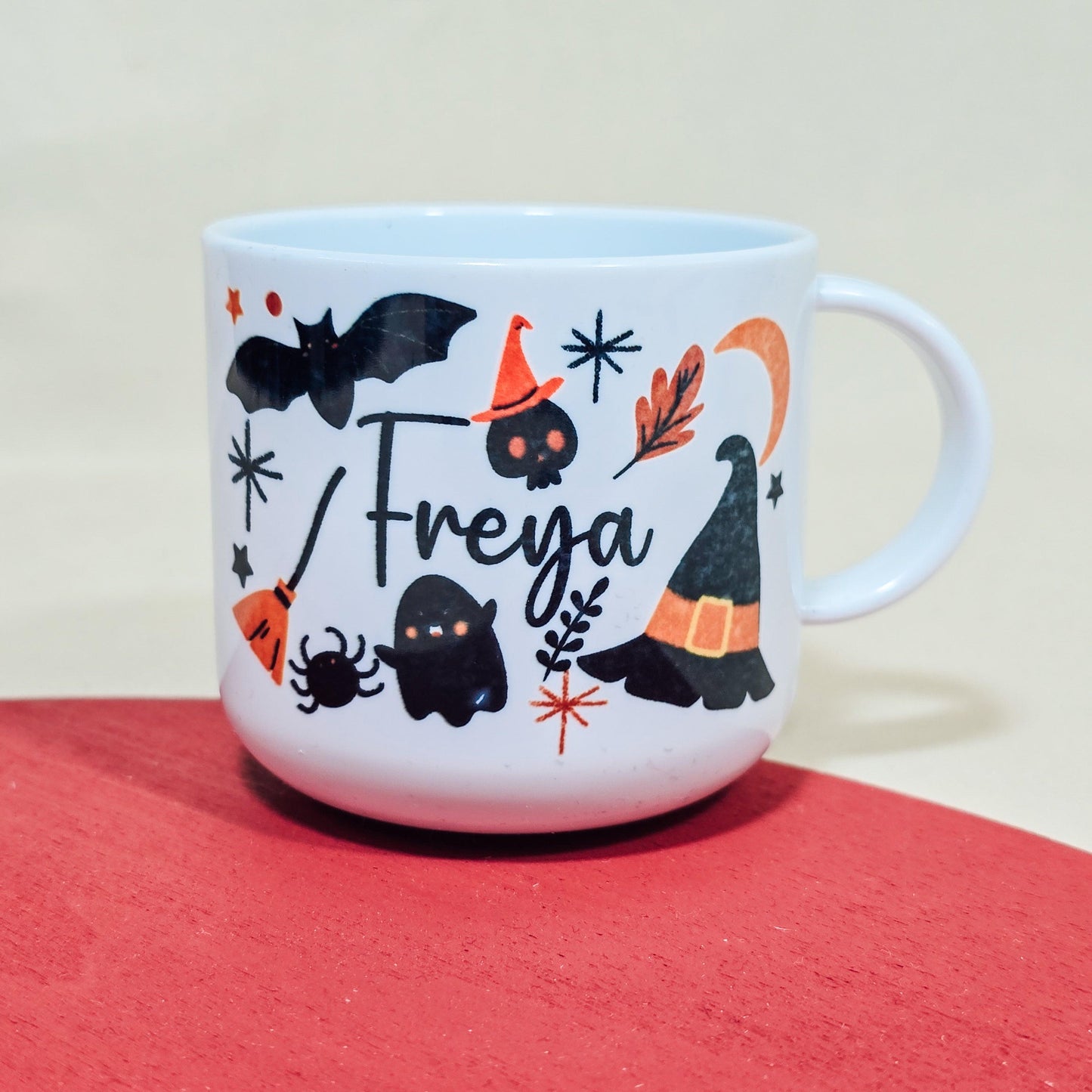 Personalised 6oz unbreakable Halloween kids mug featuring bats, witches hats, and custom name. Option to add a matching adult mug.